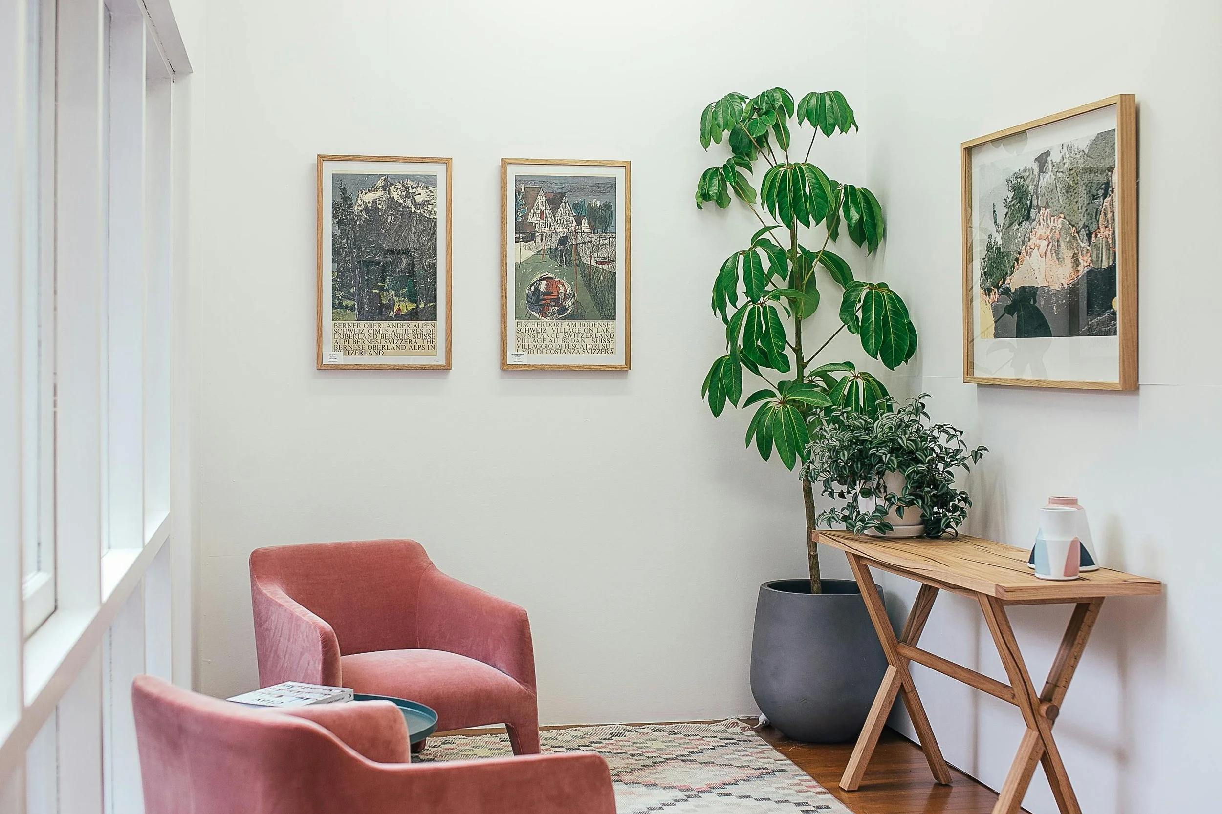 office office with pink chairs and artwork on walls