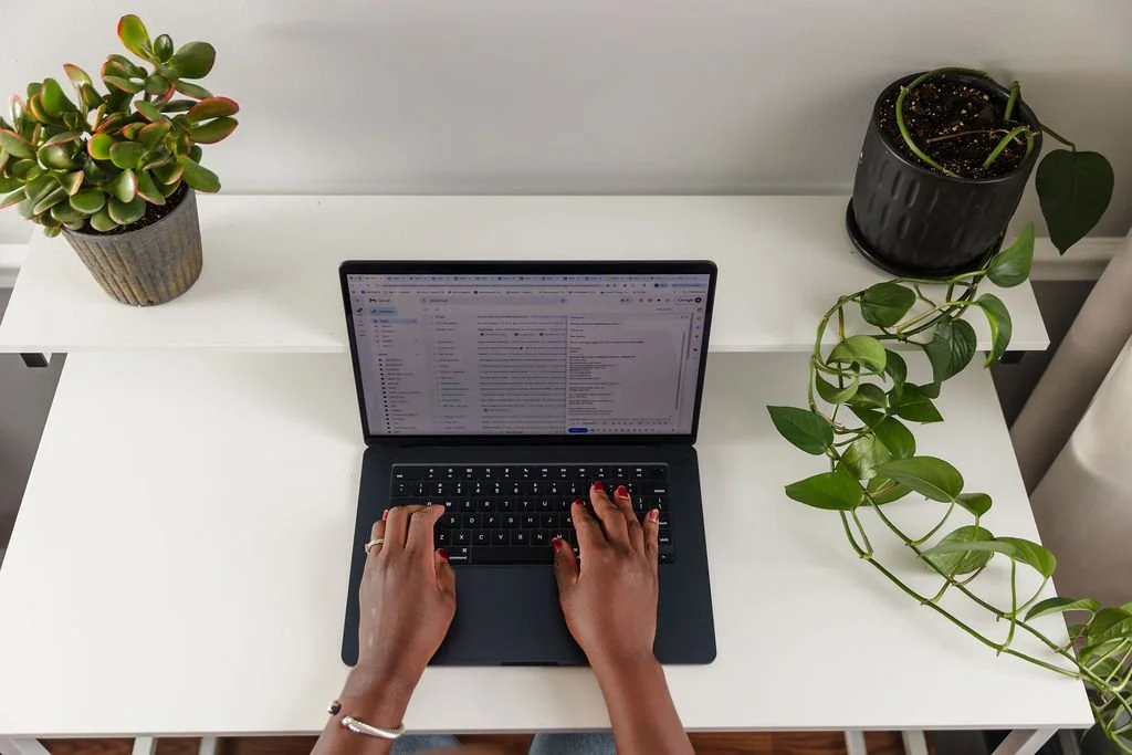 A woman typing on laptop
