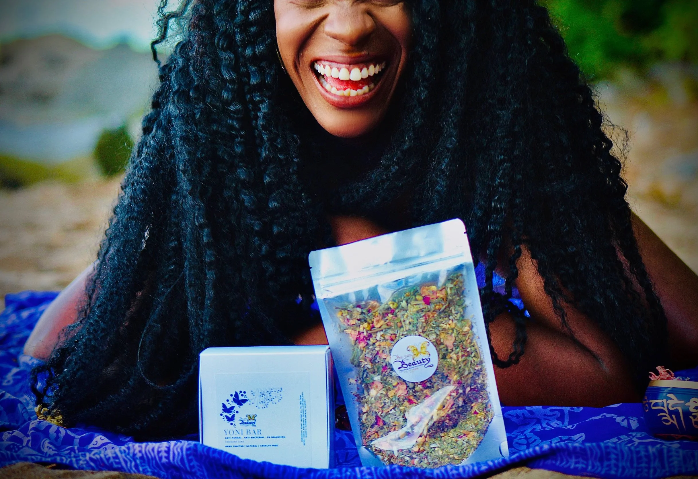 Bianca Pitman, holistic feminine wellness founder of Be You Beauty, smiling with her products in natural light