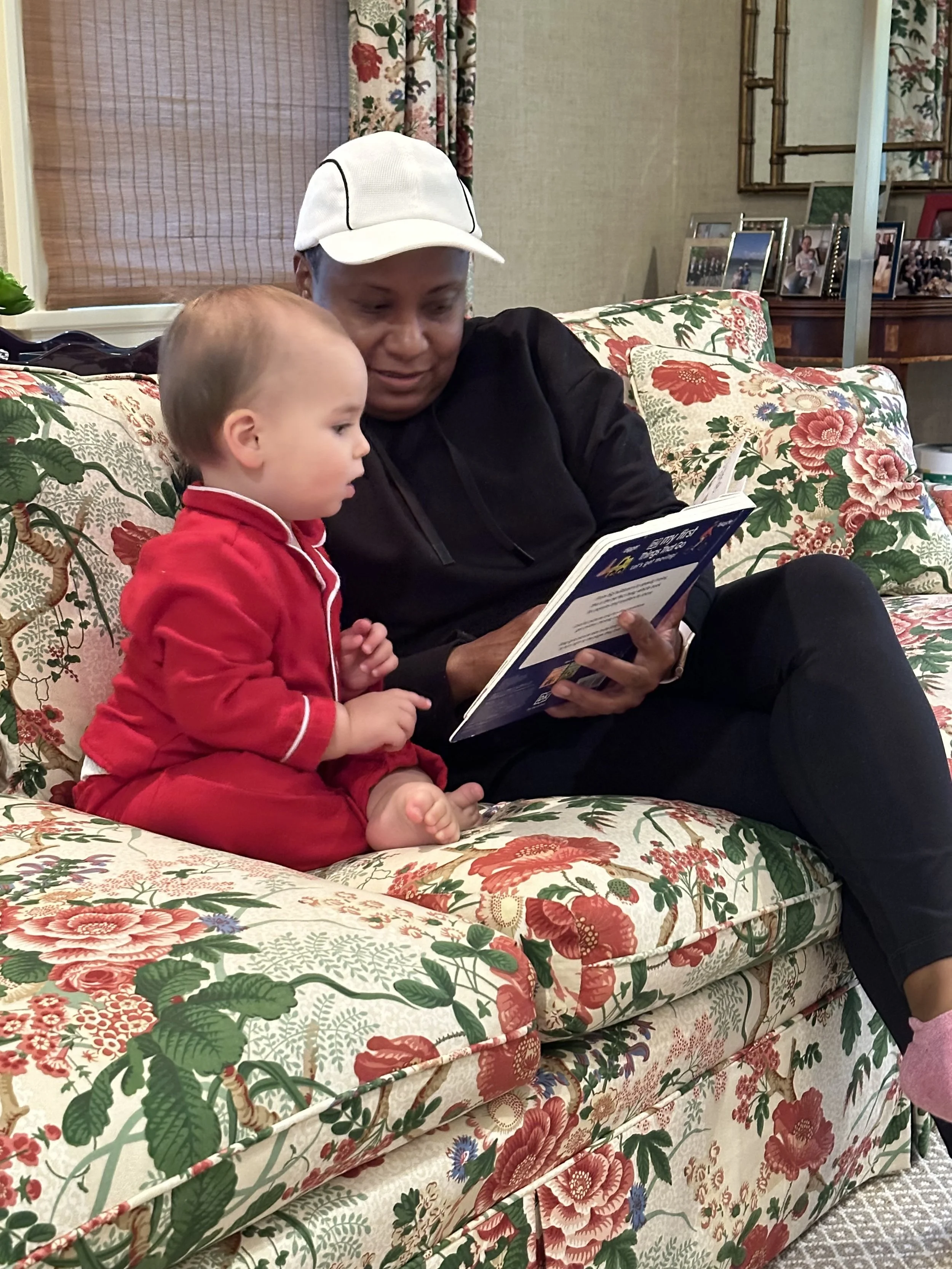 Ria Savoy, newborn care specialist reading a book to a child in Bucks County, PA.