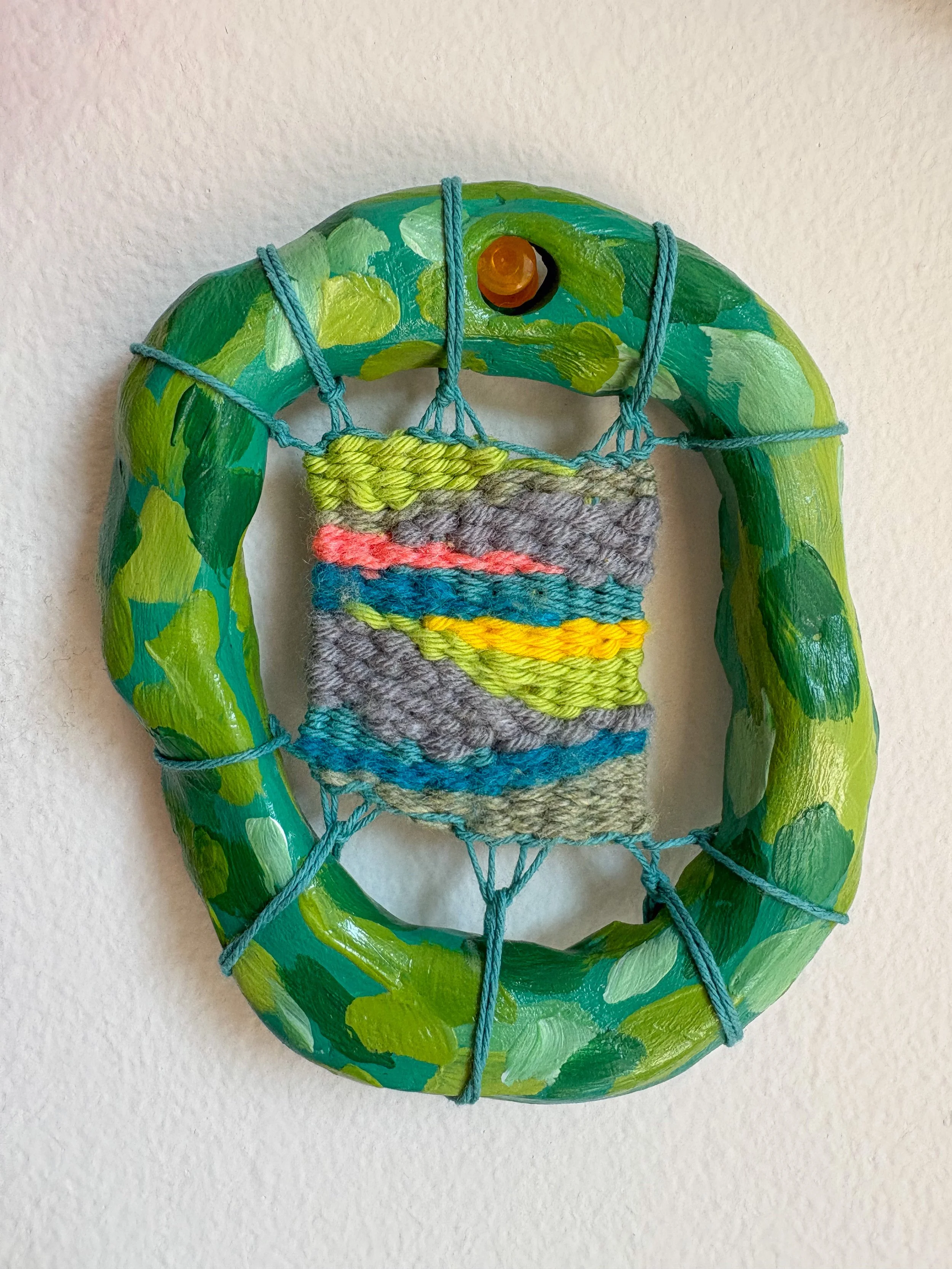 "Camo in a gay way. Black, heavily-worn, heavily-loved high top converse. A small moment of sunshine peaking through dense leaves." --- Forest (2025). 3.5" x 4" x .75". Thread, yarn, clay, acrylic paint, and glue.