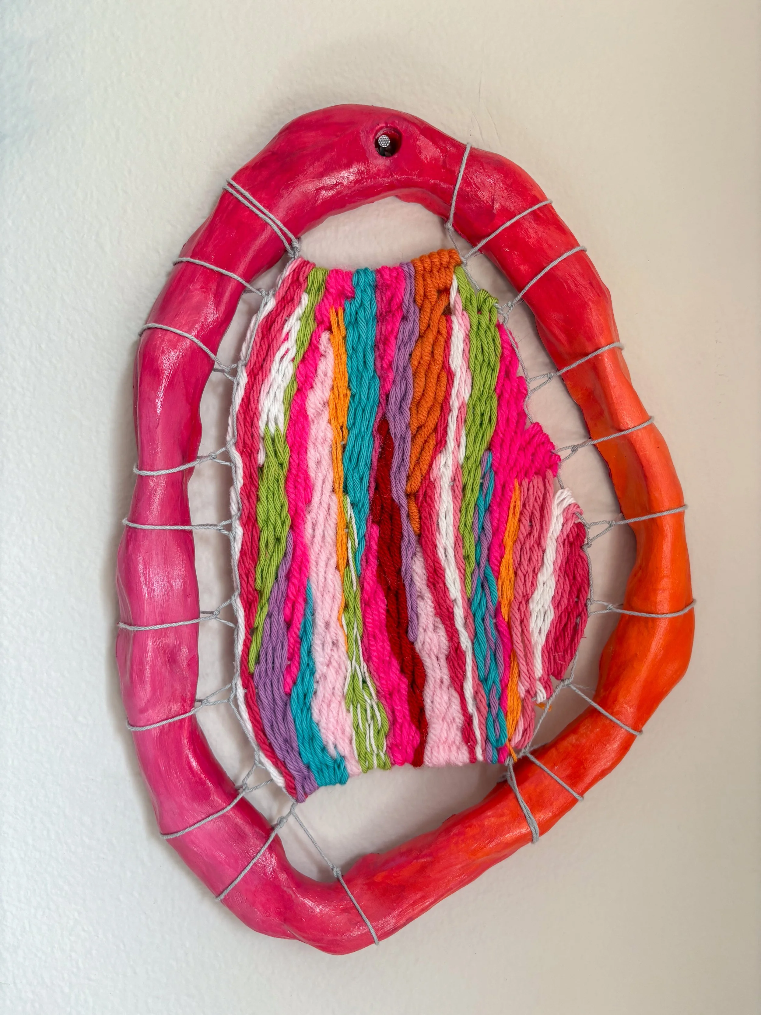 Sunset (2025). 7" x 10" x 1.25". Thread, yarn, clay, acrylic paint, ribbon, and glue. SOLD.