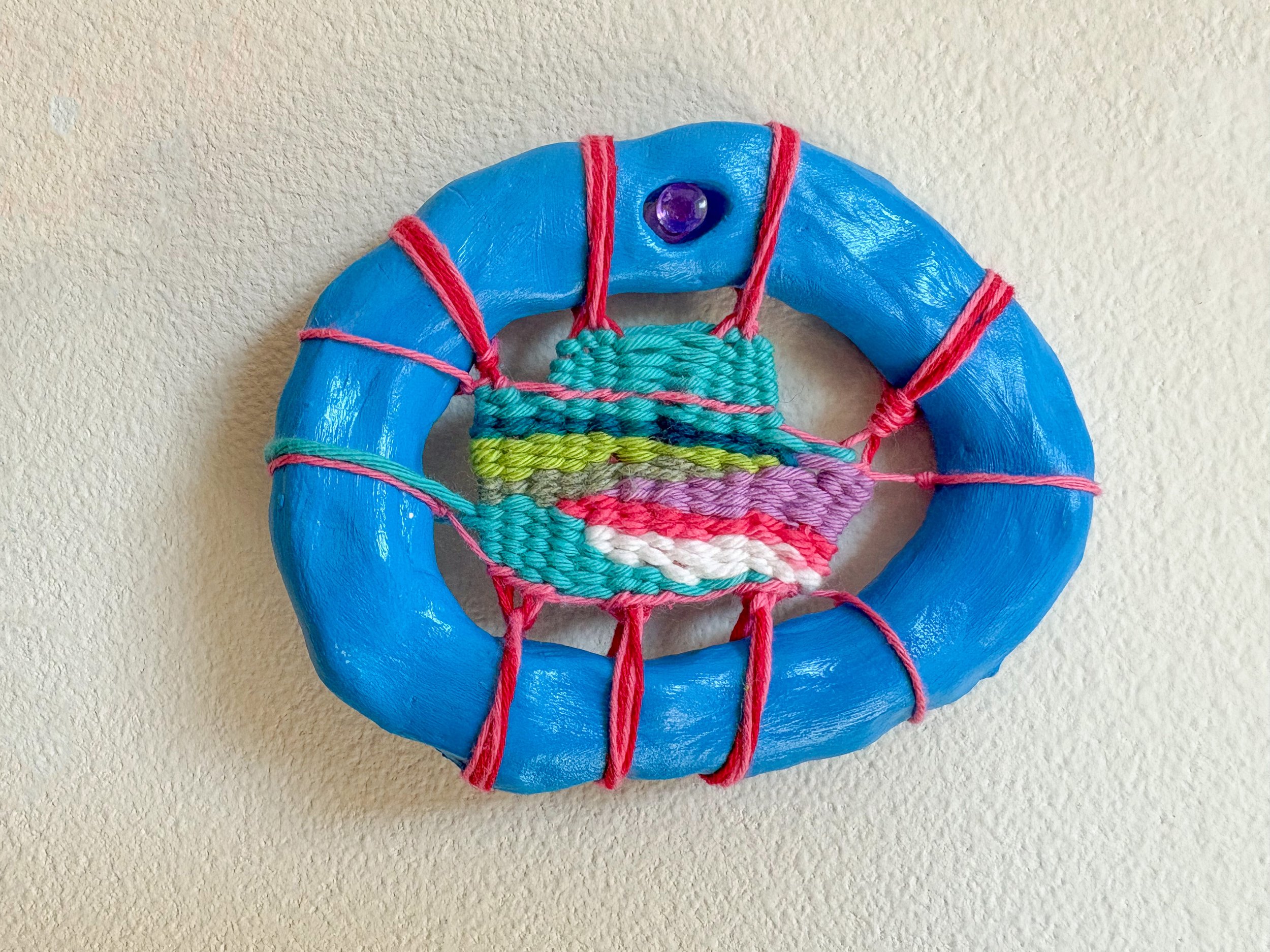 "A peanut butter blue m&m, perfectly warmed, in the middle of a bowl of movie theater buttered popcorn." --- Candy Coated (2025). 4.5" x 3.5" x .75". Thread, yarn, clay, acrylic paint, and glue. Available in shop.