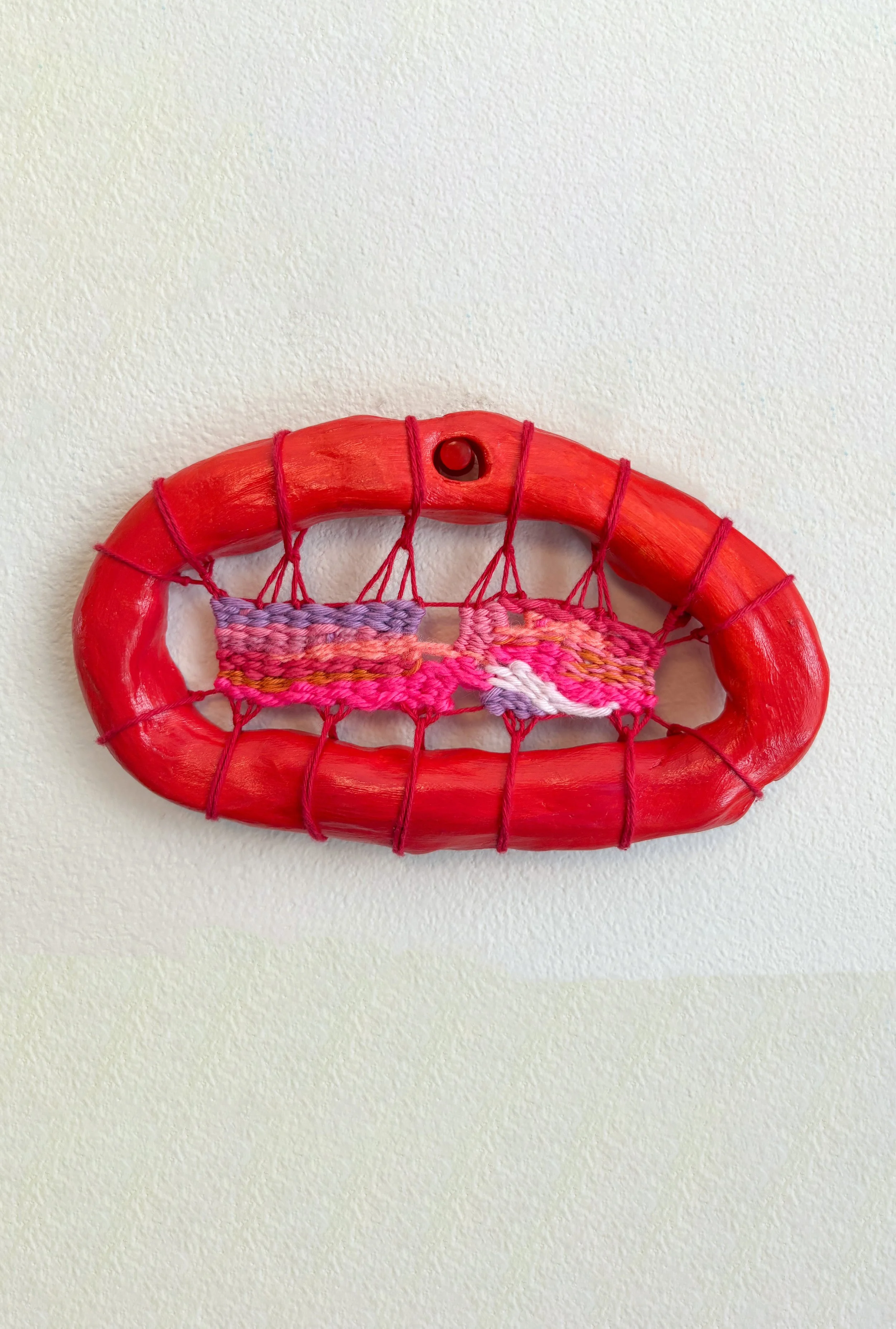 "An icy tajin-salted prickly pear margarita, sitting in the breeze of a nearby fan on a hot summers day." --- Vibrant (2025). 6.5" x 4" x .75". Thread, yarn, clay, acrylic paint, and glue. Available in shop.