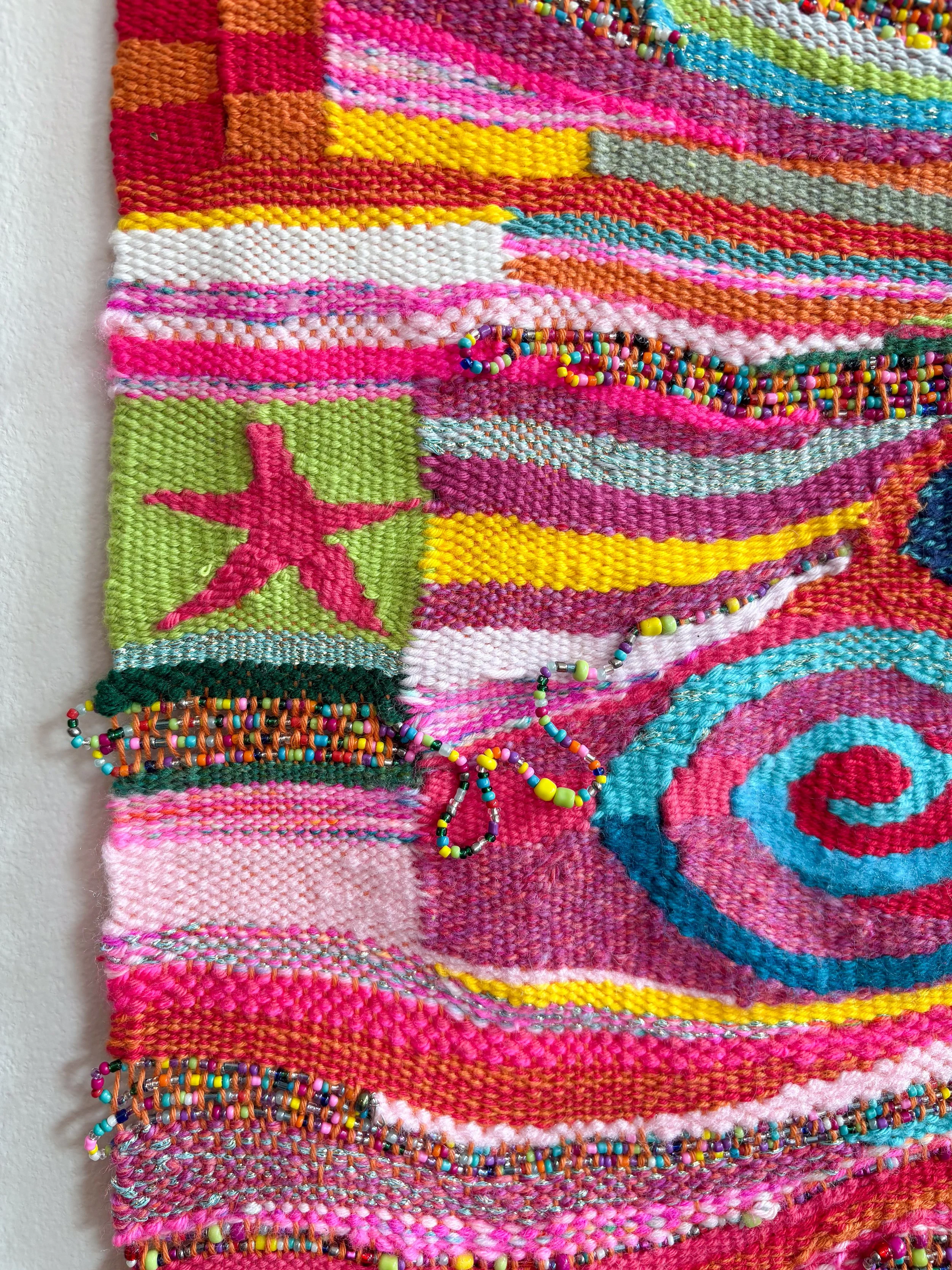 (detail) Oranges and Cinnamon, Spirals and Stars (2026). 11" x 31" x .45". Yarn, thread, beads, and wire.