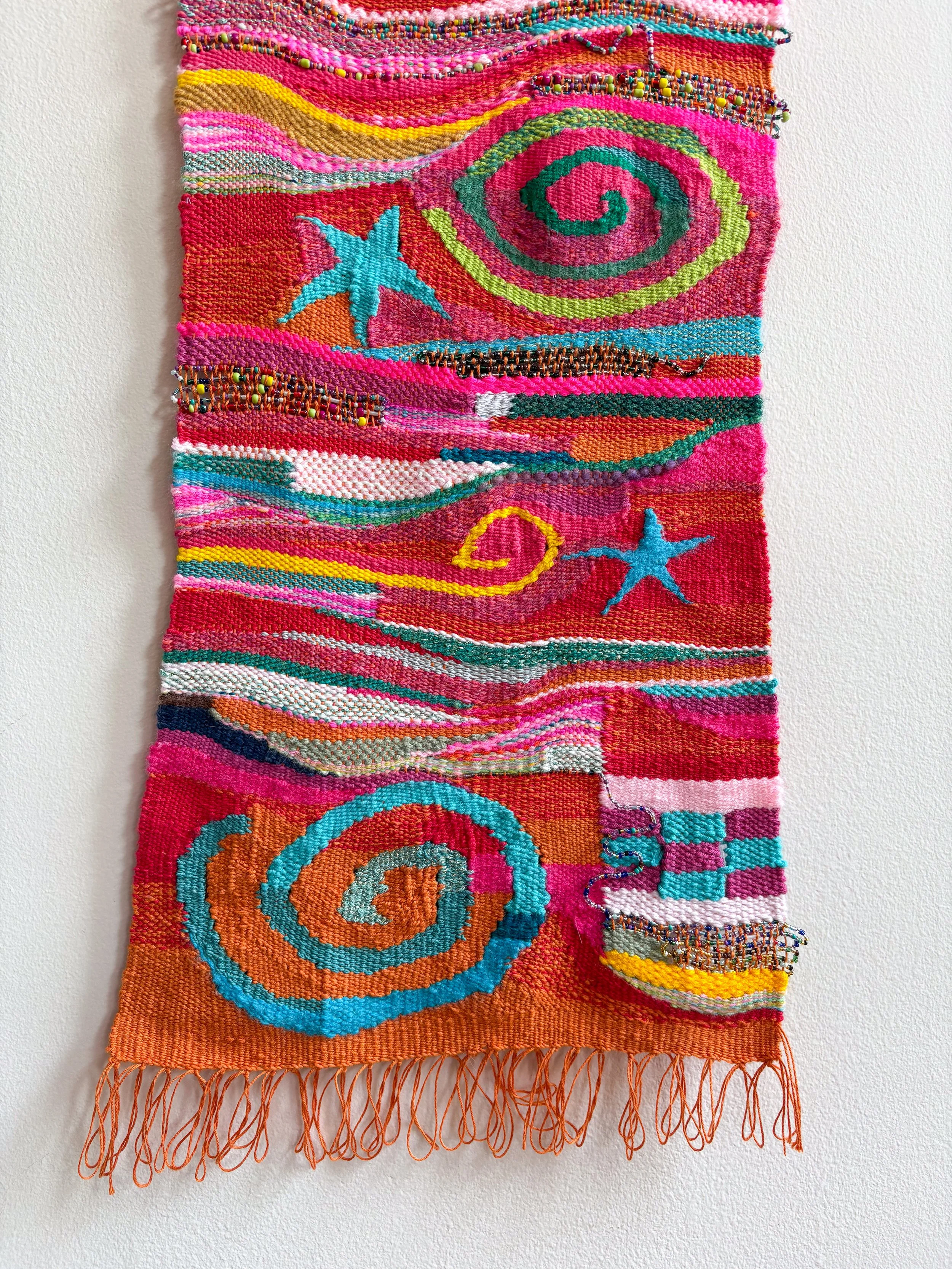 (detail) Oranges and Cinnamon, Spirals and Stars (2026). 11" x 31" x .45". Yarn, thread, beads, and wire.