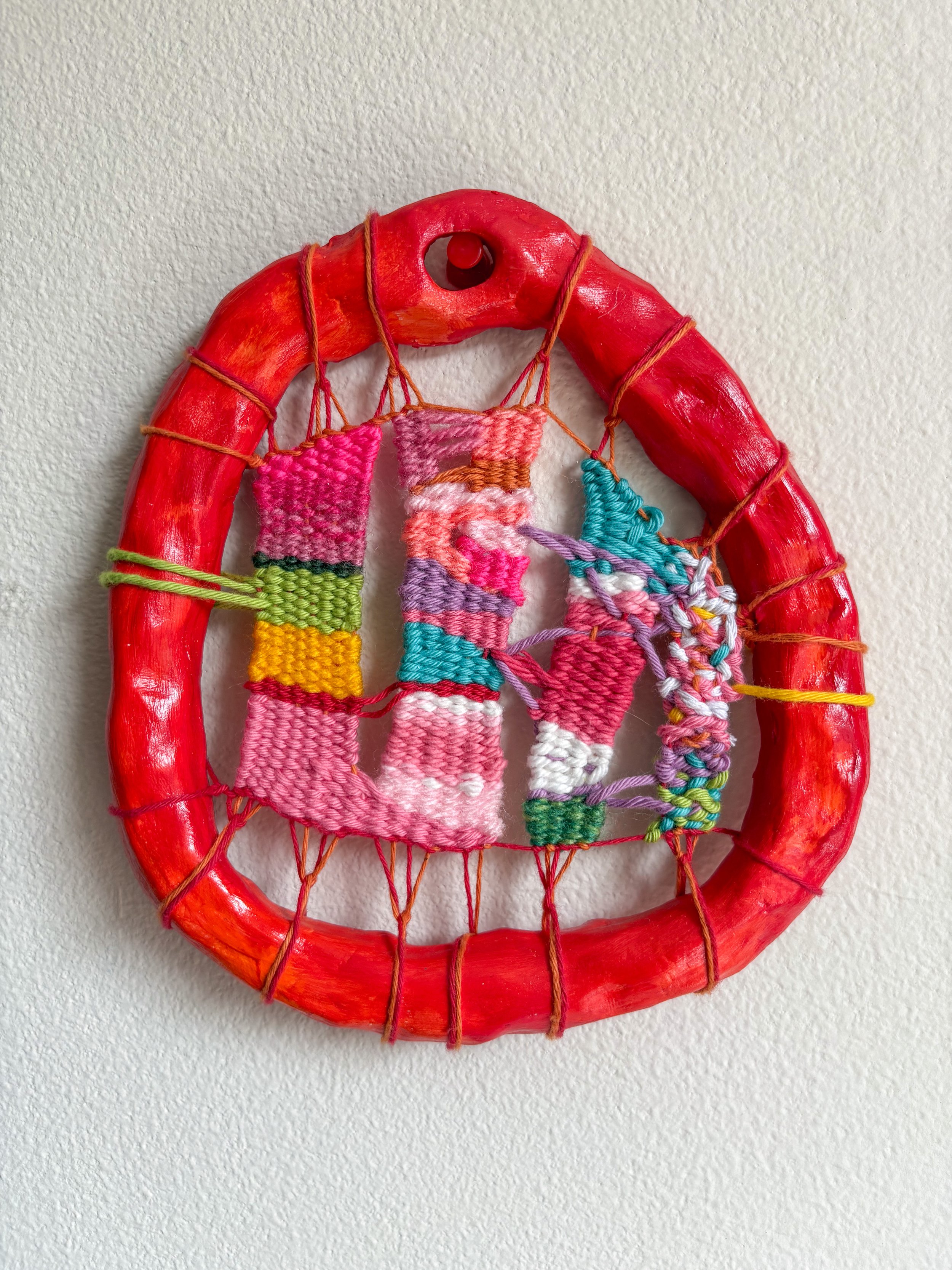Unravelling (2025). 6.5" x 6" x 1". Thread, yarn, clay, acrylic paint, and glue.