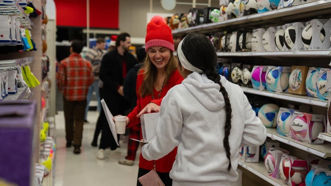 Child and volunteer participating in a Denver Children’s Foundation holiday giving program
