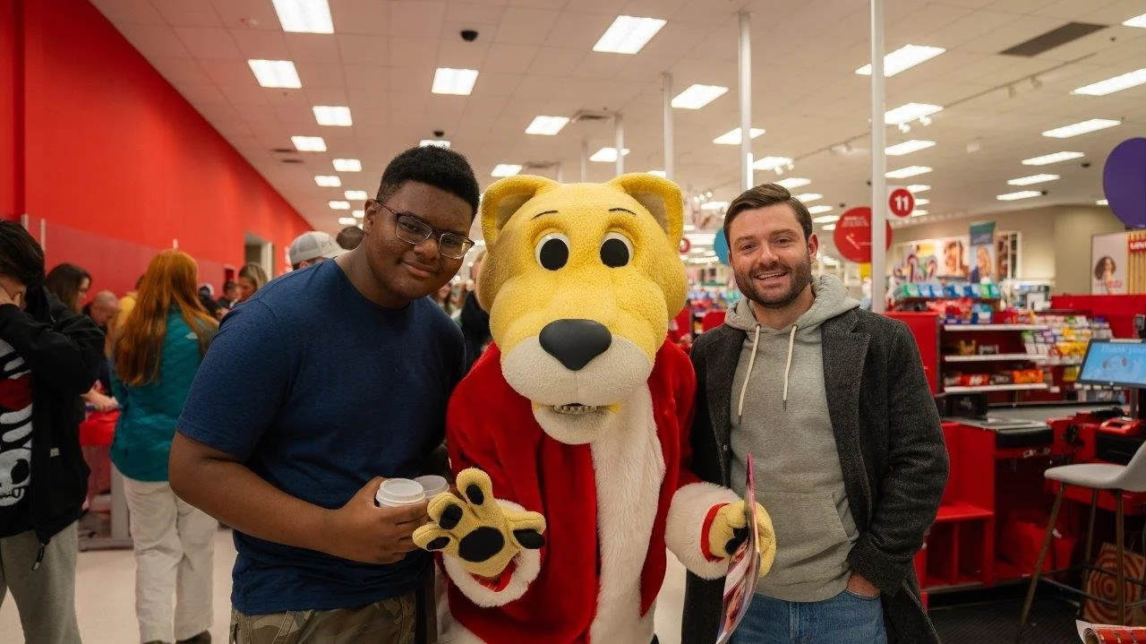 Denver Children’s Foundation Christmas for Kids event with Rocky the Denver Nuggets mascot and participants shopping for gifts