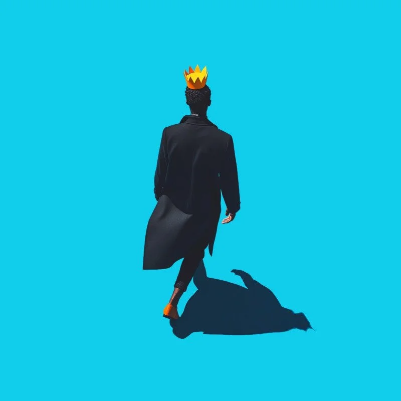 A person dressed in black walking on a blue surface with a yellow and orange crown hat on their head, casting a shadow.