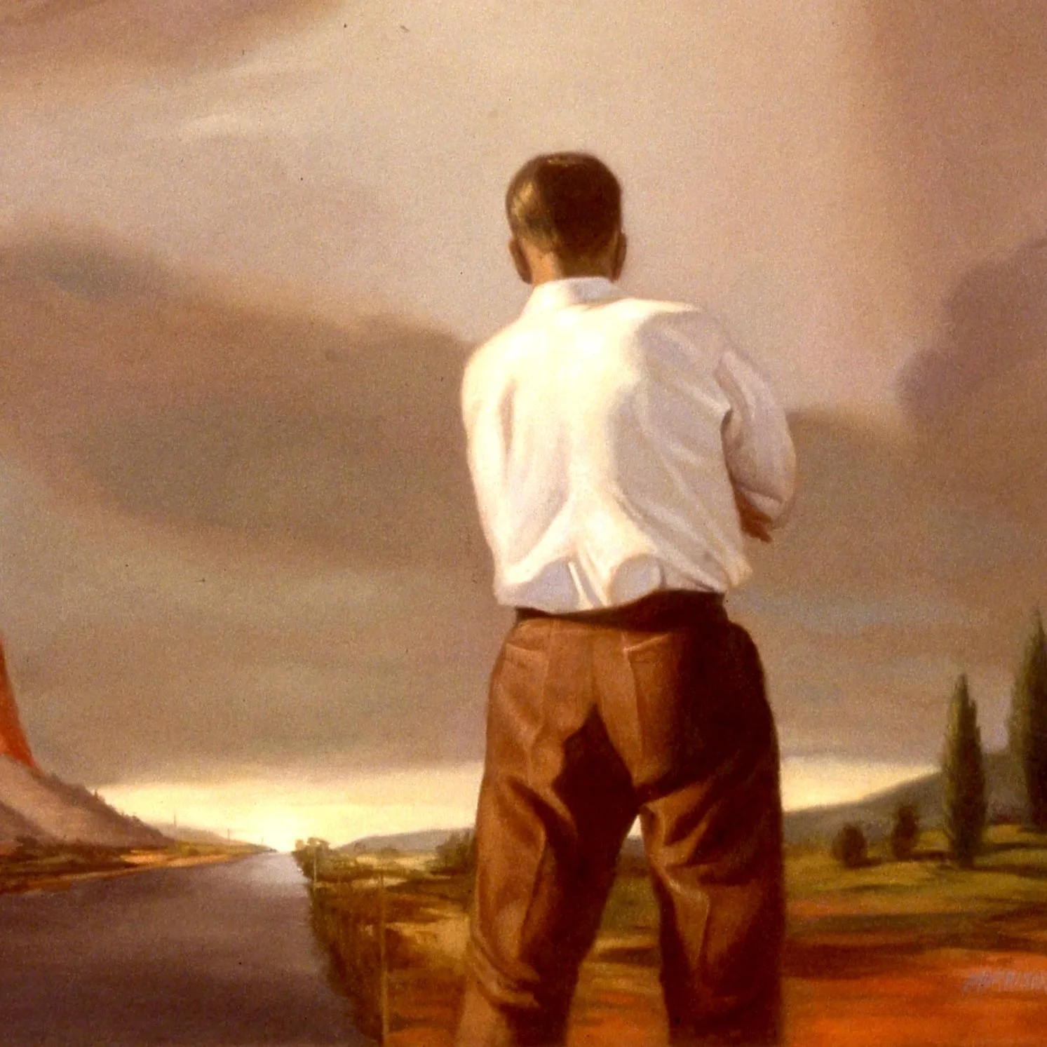 Young man wearing a white shirt and brown pants, standing outdoors on a boardwalk, looking at the sky with a stormy background.