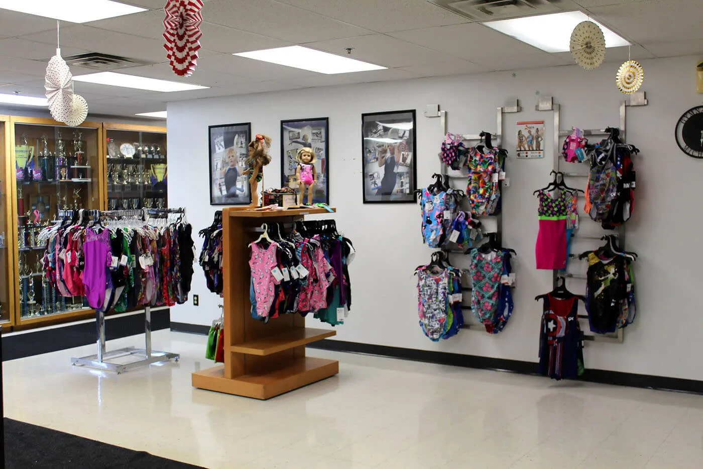 Children's gymnastics apparel store display with leotards and more.