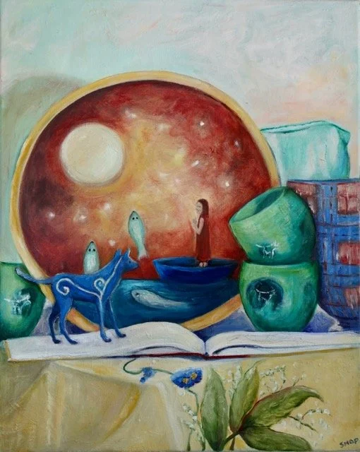 Still life painting with a large round frame showing a starry sky and sun, fish in bowls, a woman, and a blue dog on an open book, with stacked bowls, a flower, and a container in the background.