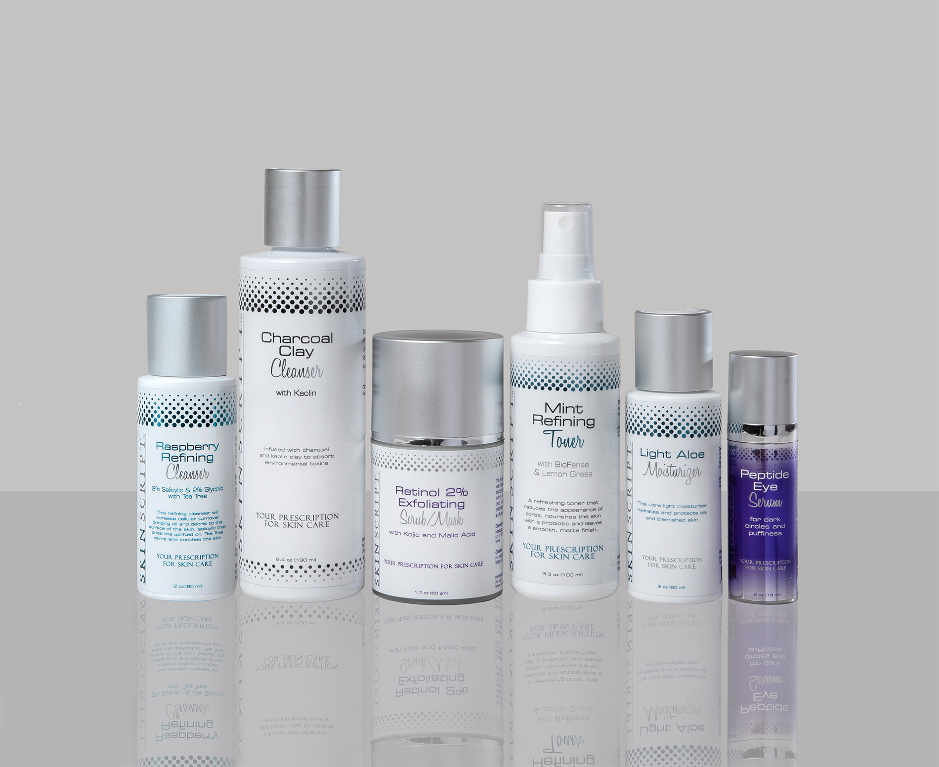 Collection of skincare products including cleansers, masks, moisturizers, and serums on a reflective surface.