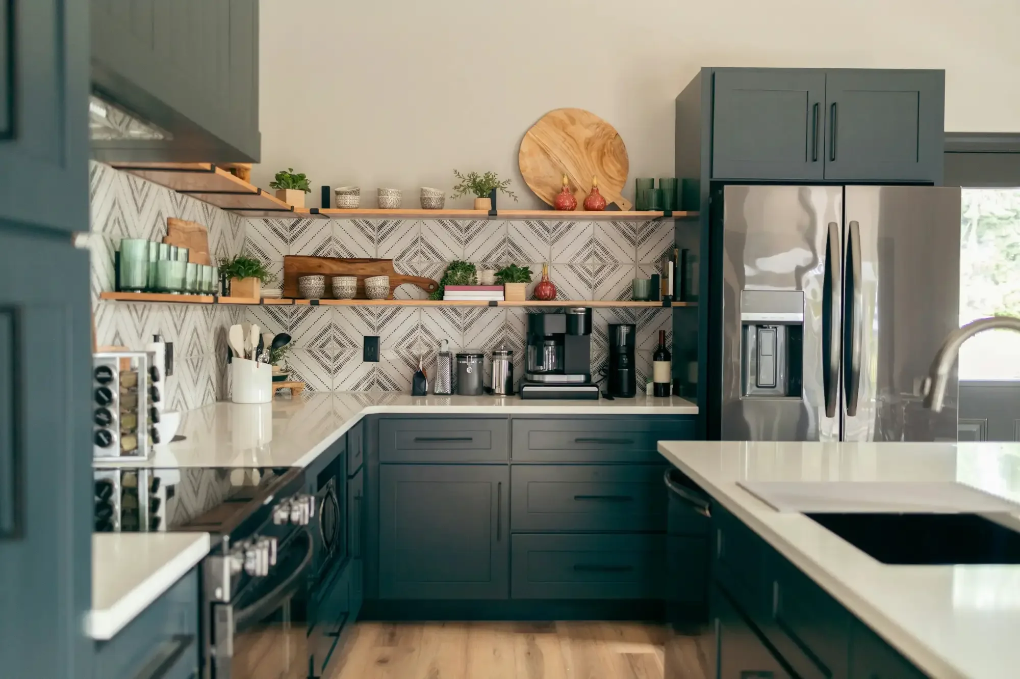 Modern kitchen with dark cabinets, open shelves, geometric backsplash, and stainless appliances—makes you wonder, is deep clean worth it?