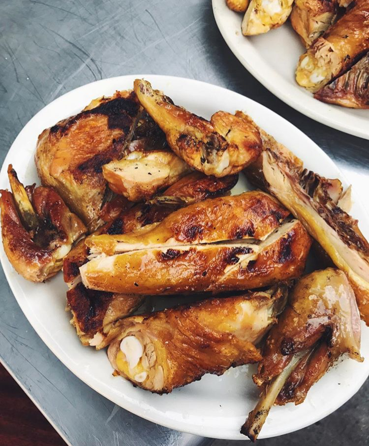 Cooked fried chicken served on a white oval plate.