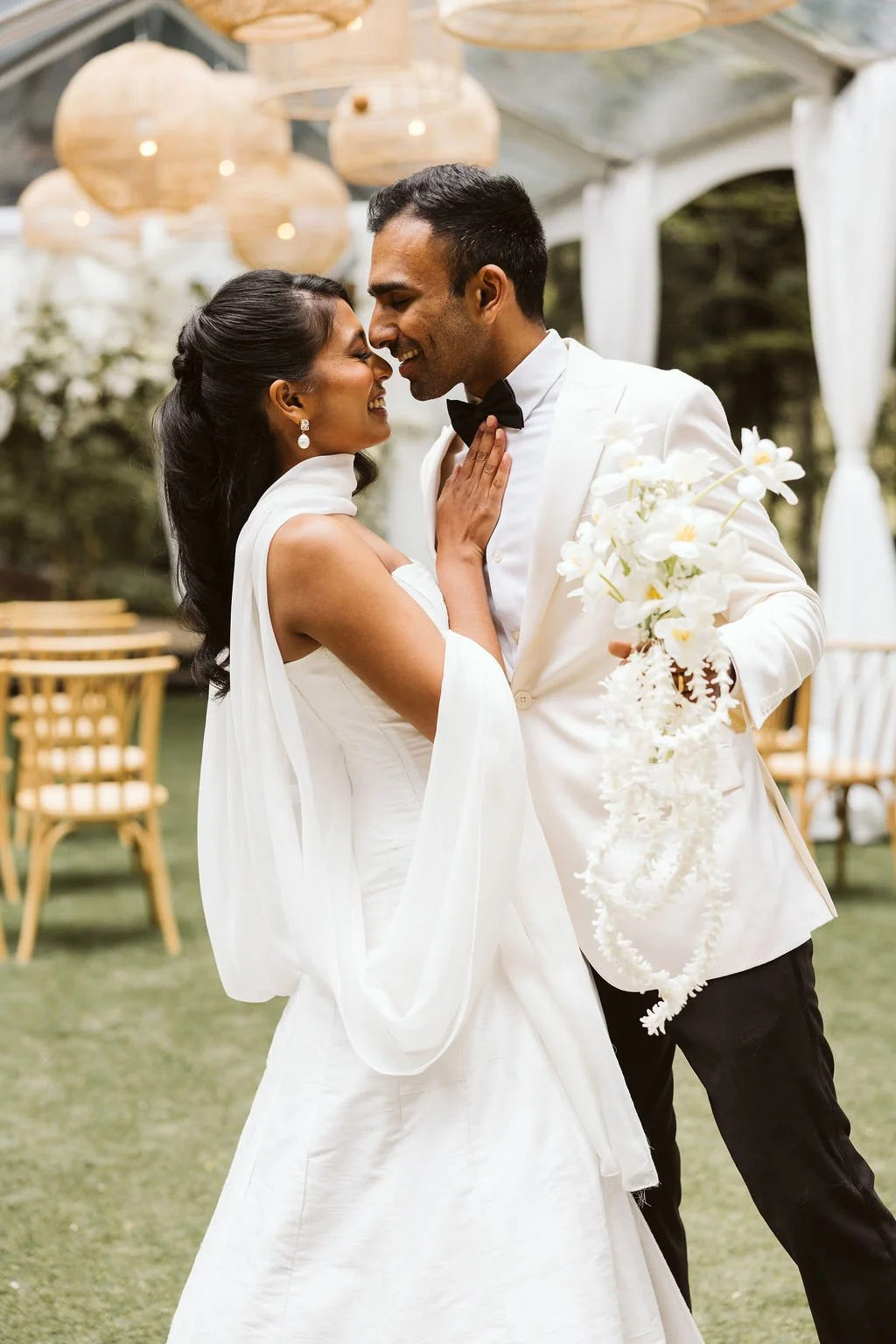 A bride and groom share a joyful, close moment during their wedding reception outdoors, with the groom holding a bouquet of white flowers.
Makeup Karla, Bridal Beauty Agency
Hair Lindsey Bridal Beauty Agency
Venue: JM Cellars
Planning & Design: Audre