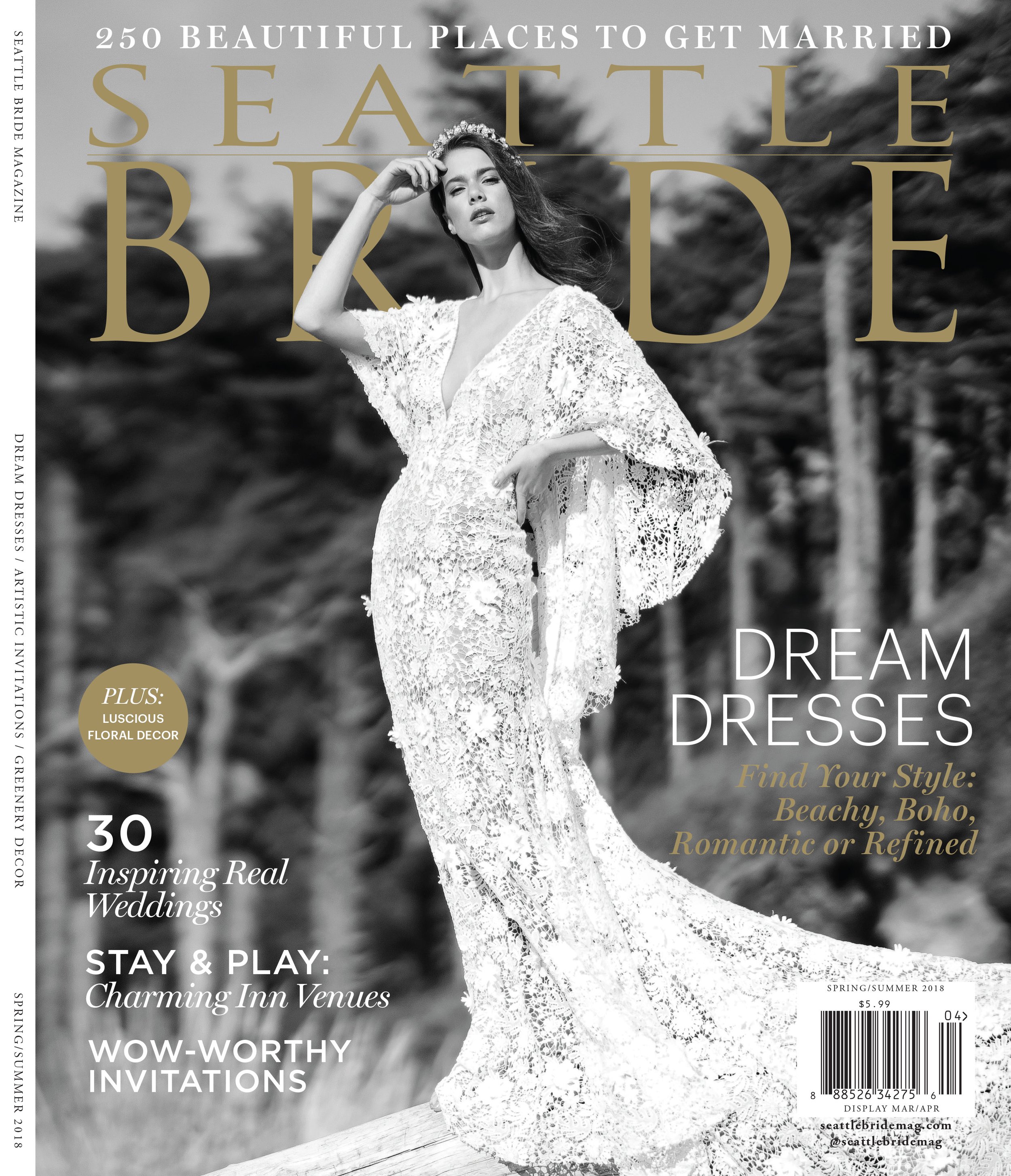 A woman in a white lace wedding dress with a floral crown standing outdoors against a cloudy sky and natural background, with text overlay for cover of Seattle Bride magazine Spring/Summer 2018 issue.