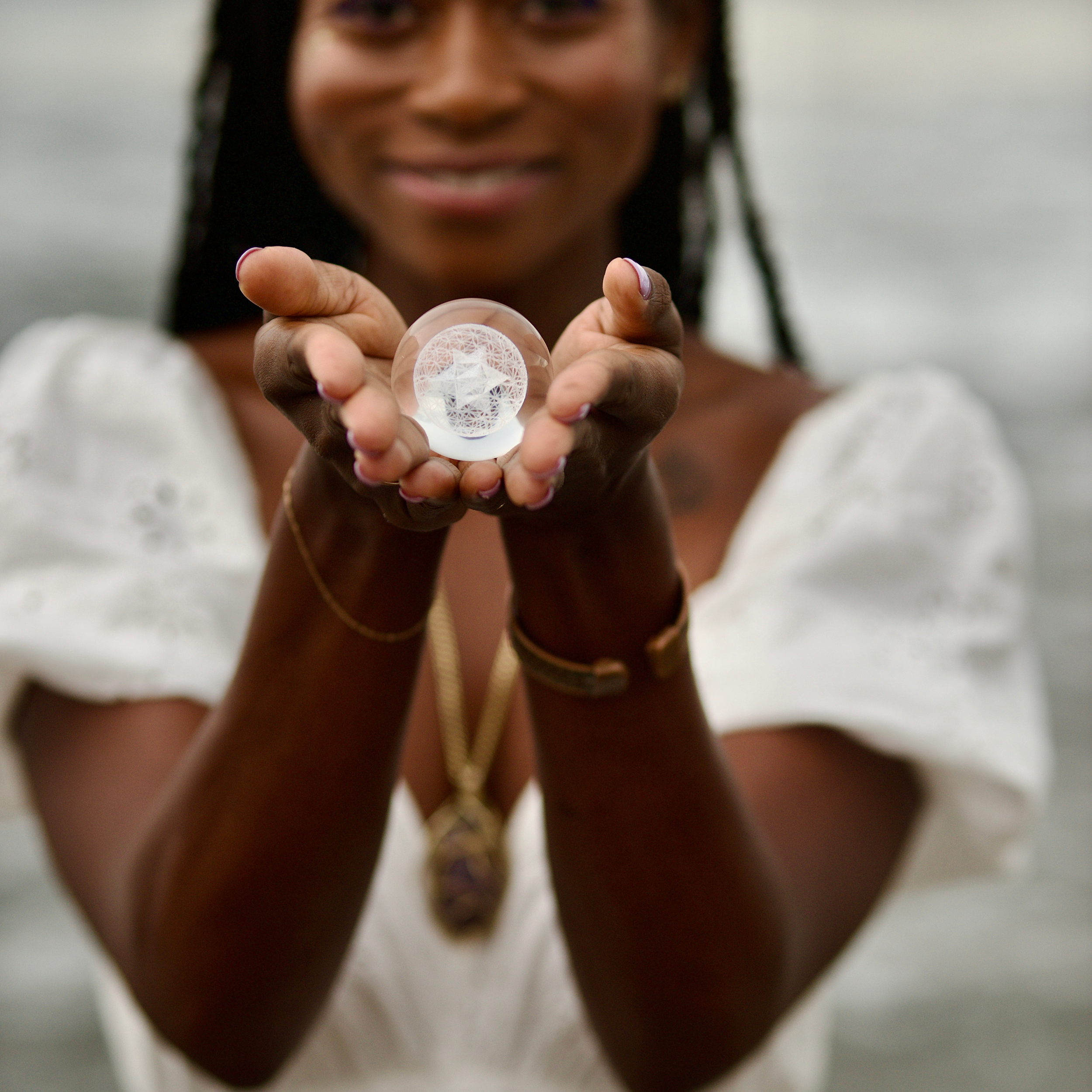 Black woman holding a gemstone during a spiritual oracle practice