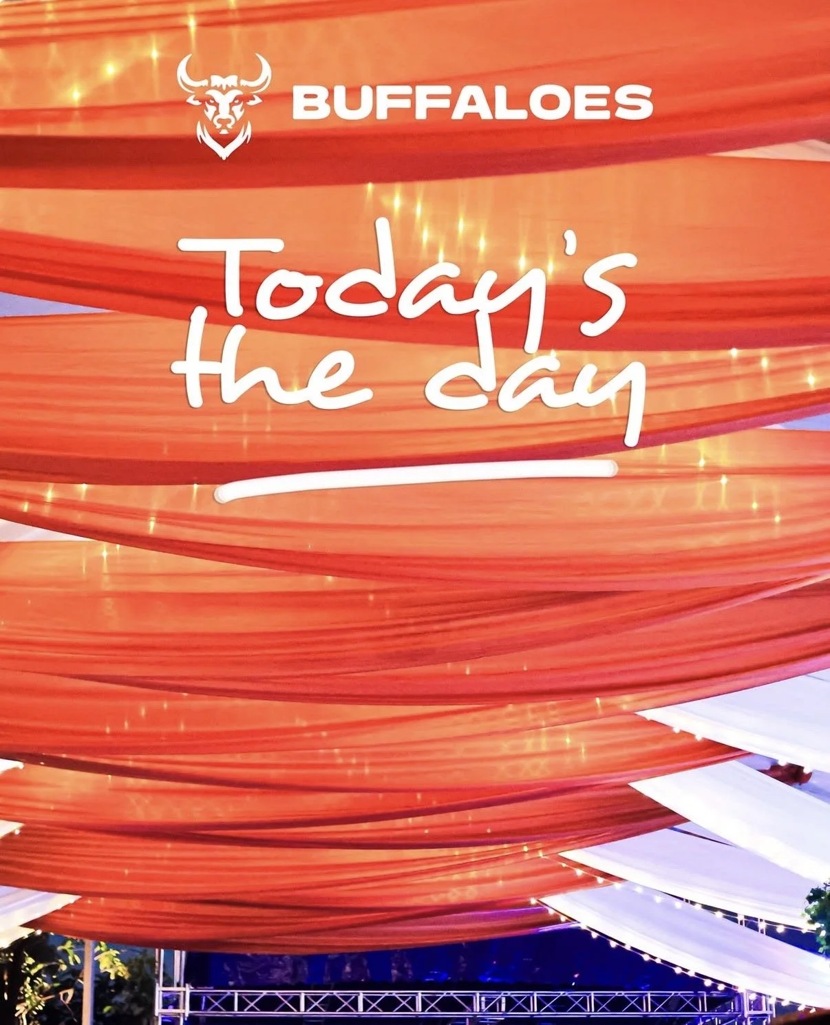 Colorful canopy decorated with drapes and string lights, with a sign reading "Buffaloes Today's the day."