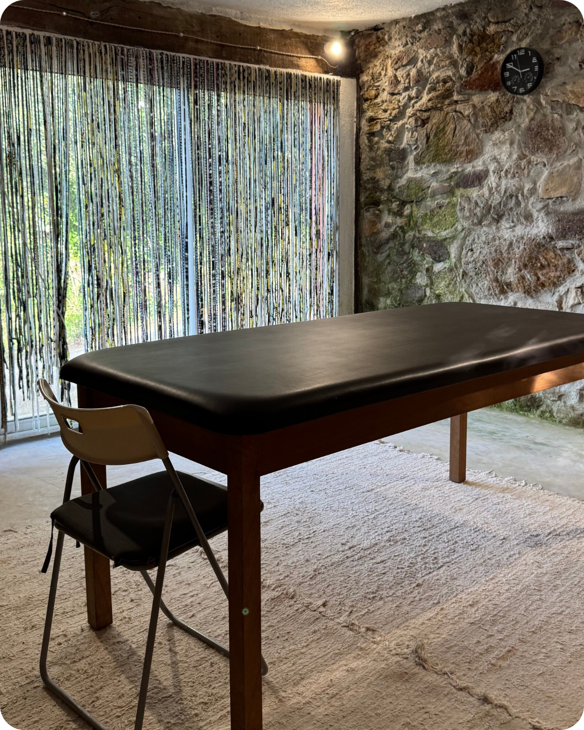 Bodywork studio in Girona with a massage table and chair