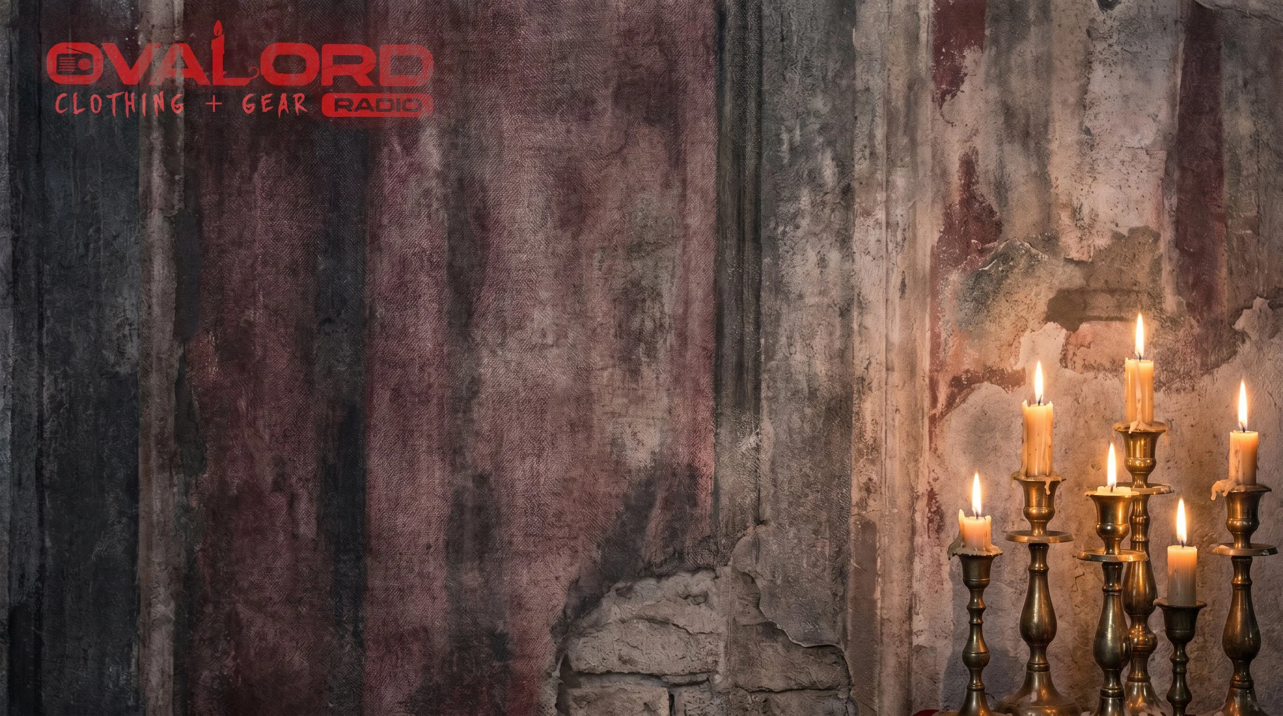 A red logo and text on a weathered, old brick wall with lit candles in brass holders at the bottom right corner.
