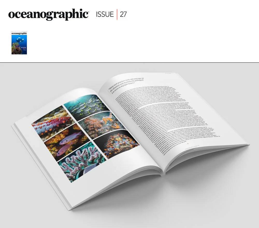Open magazine featuring underwater coral reefs and marine life photographs.