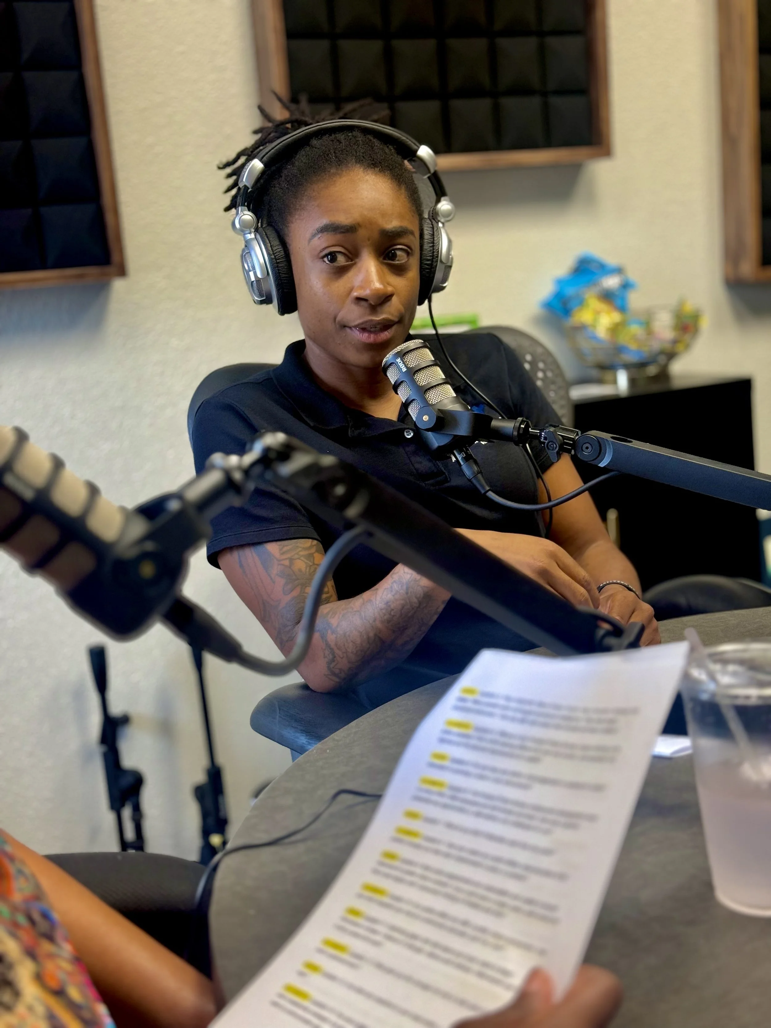 Rashida Saunders recording a podcast conversation in a studio.