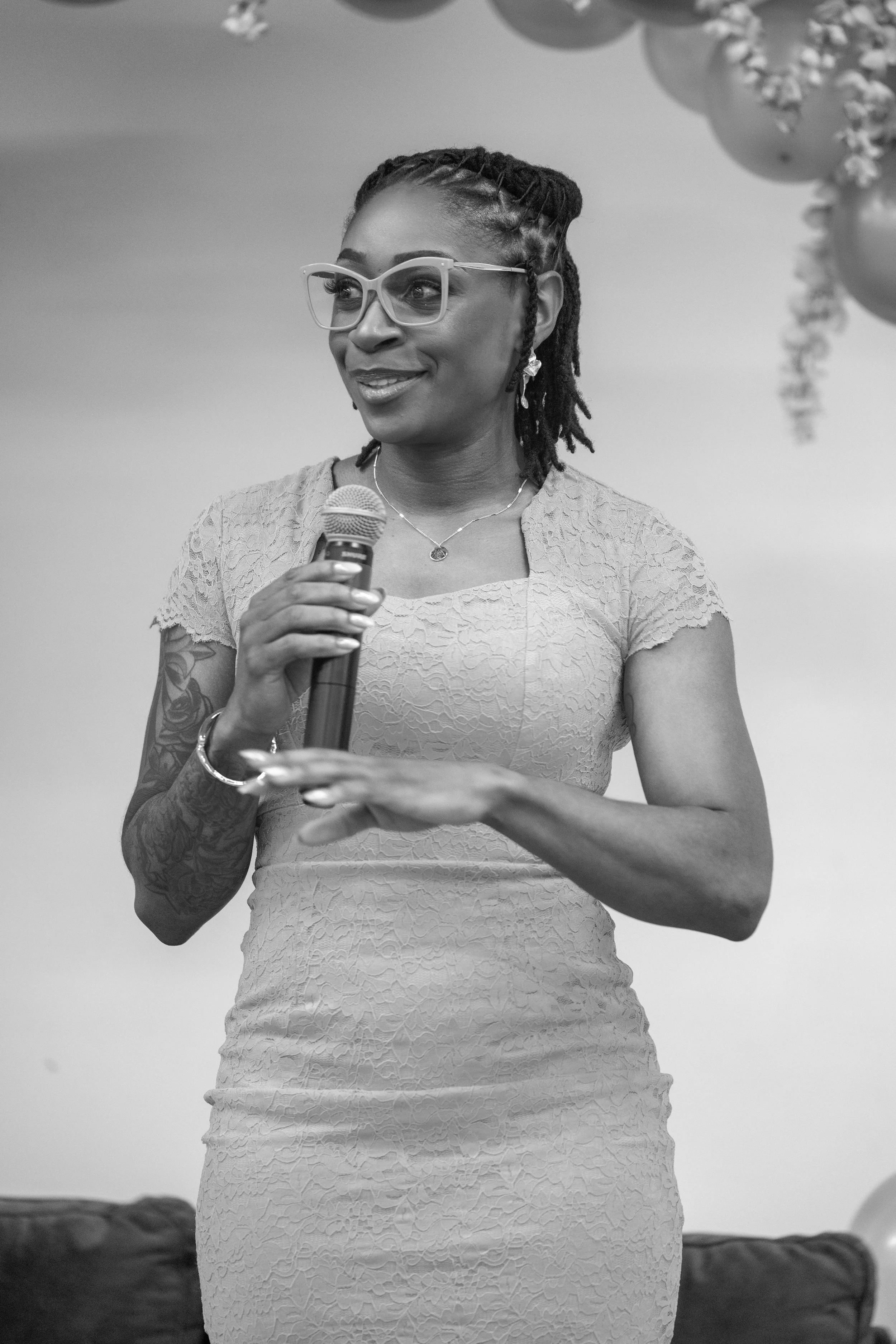 Rashida Saunders speaking to an audience during a community event.