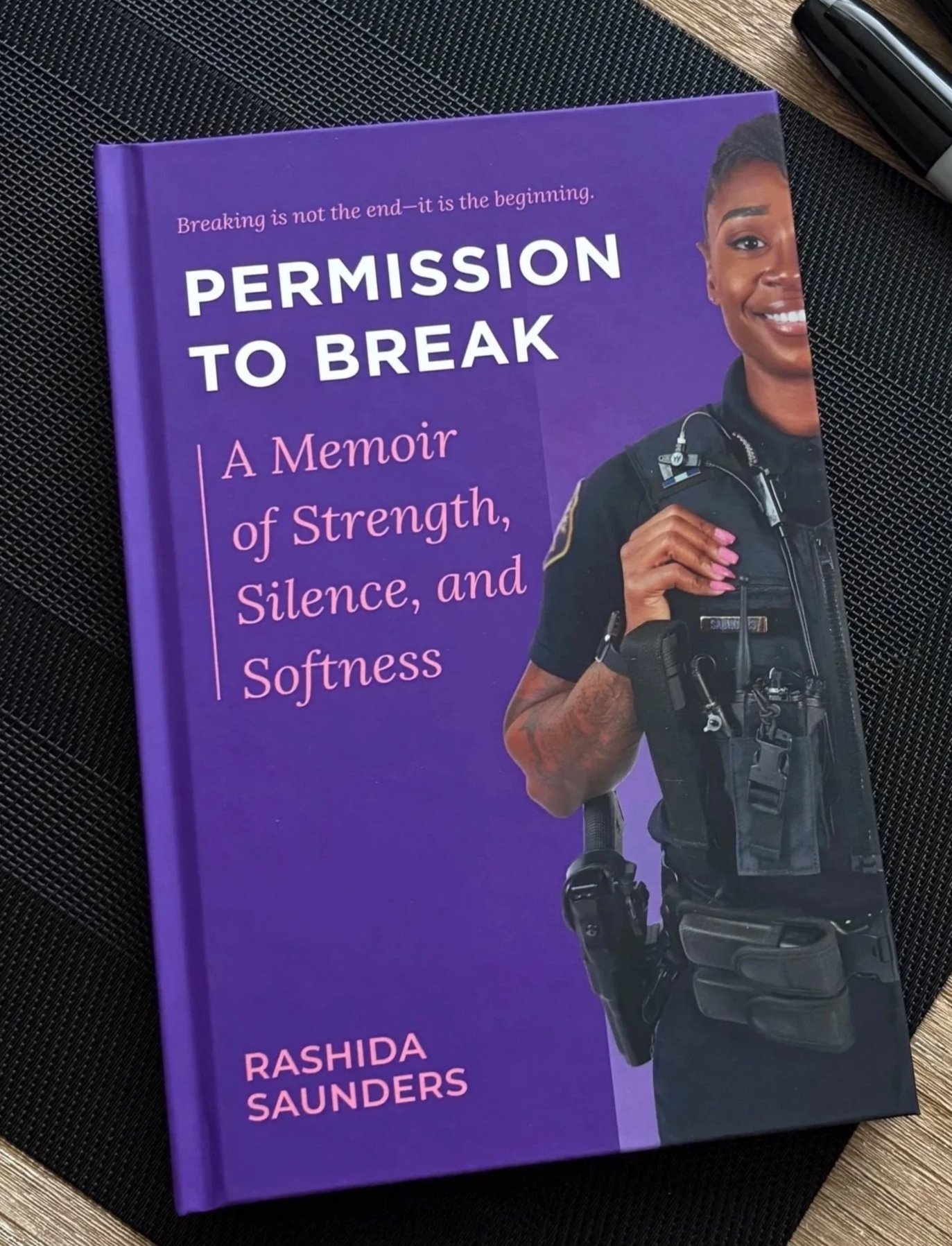 Book cover of “Permission to Break” by Rashida Saunders, featuring a Black female police officer in uniform.