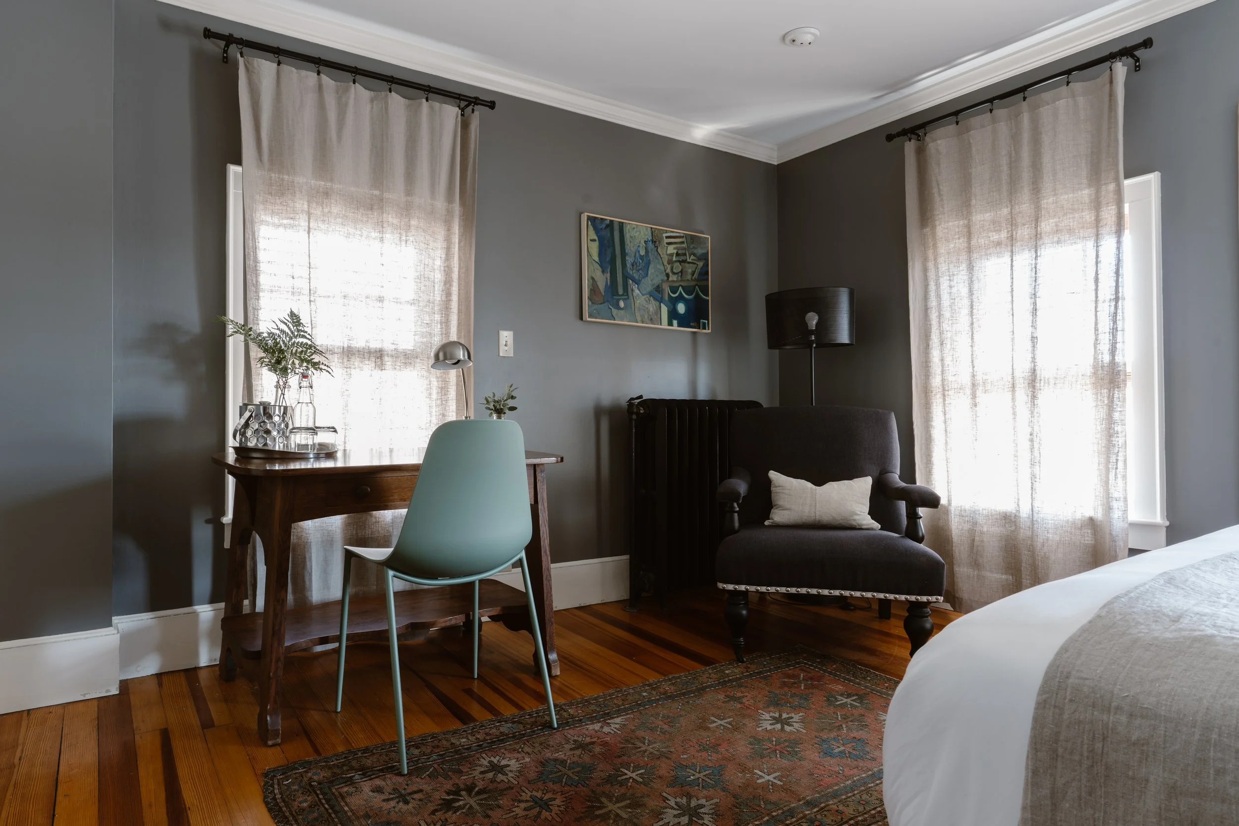 Hotel room with desk and armchair