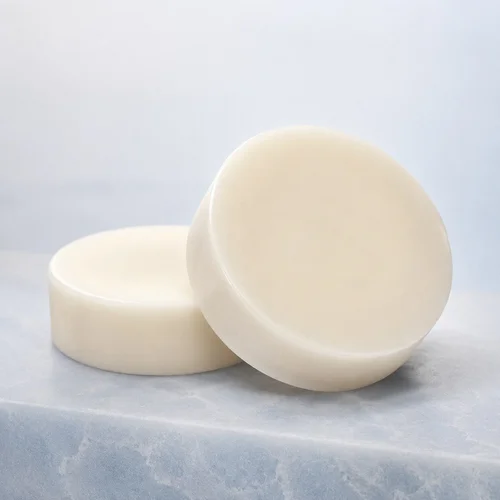 Two ivory Serevia fragrance-free cleansing bars on a soft blue stone surface.