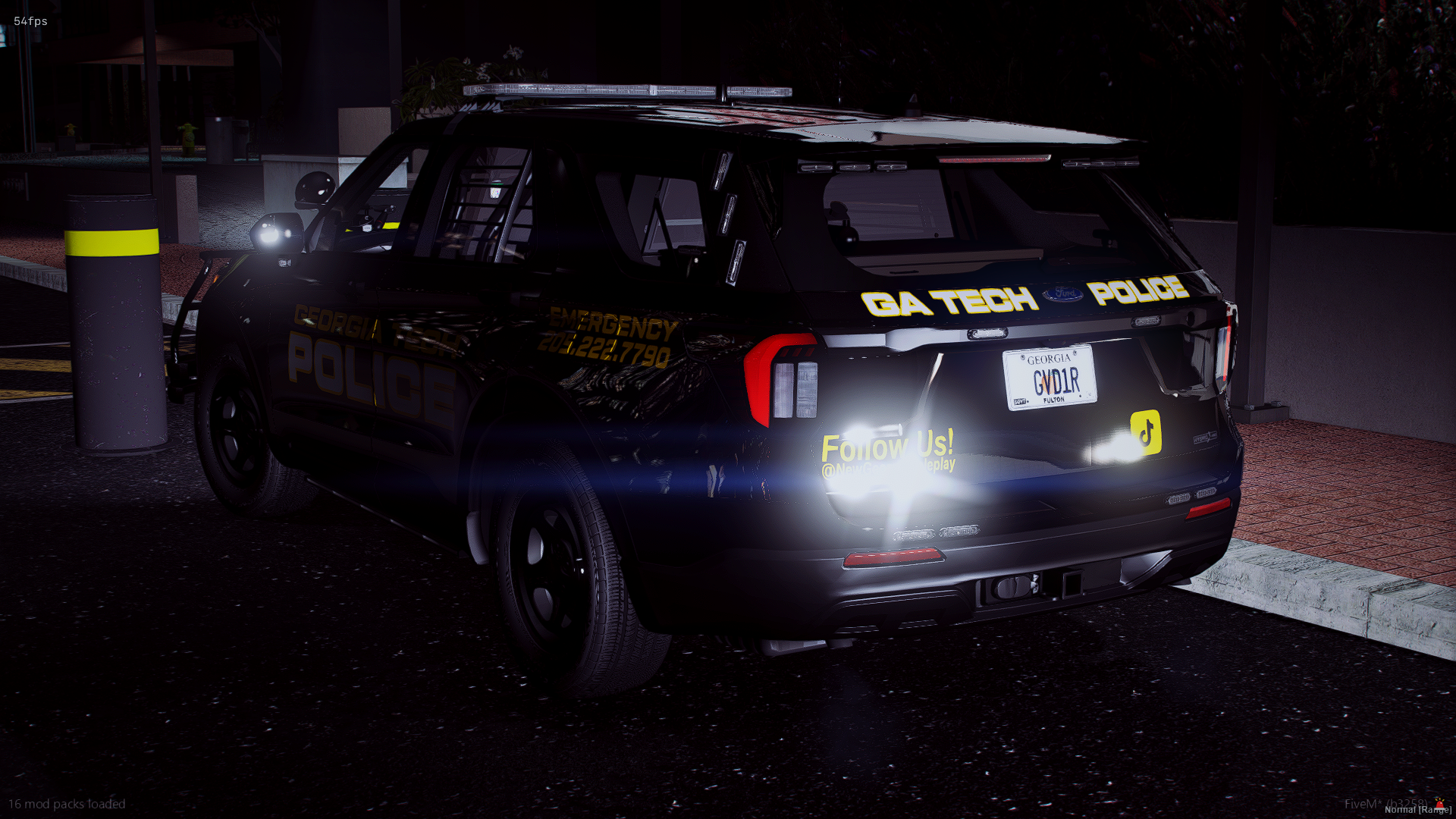 Black police vehicle with Georgia license plate, illuminated by headlights and taillights at night, with yellow text on the rear window that says 'Follow Us! @NewGeorgiaRoleplay' and parking lot surroundings.