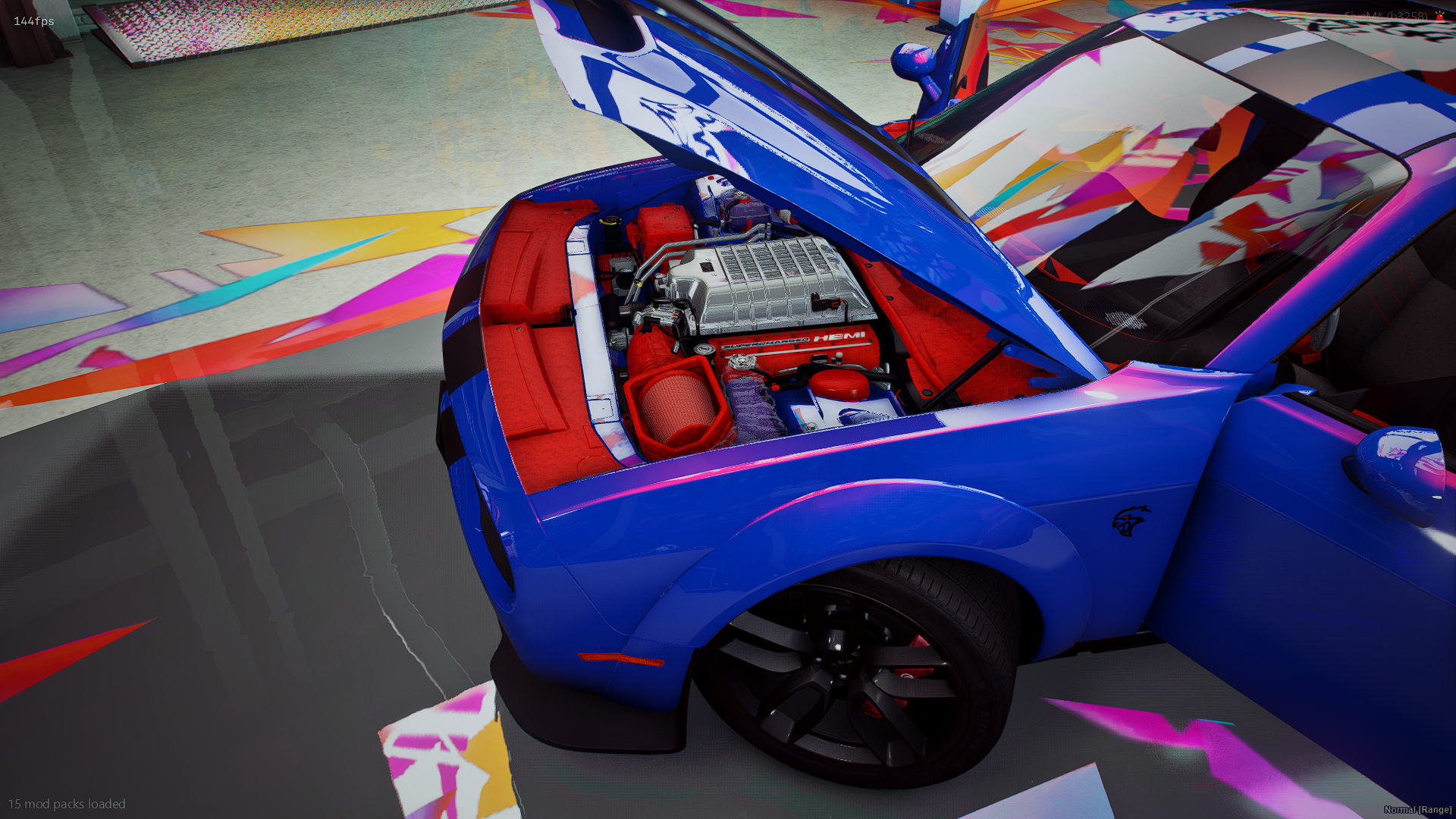 A blue sports car with its hood open, revealing the engine, in a room with colorful, abstract floor patterns.