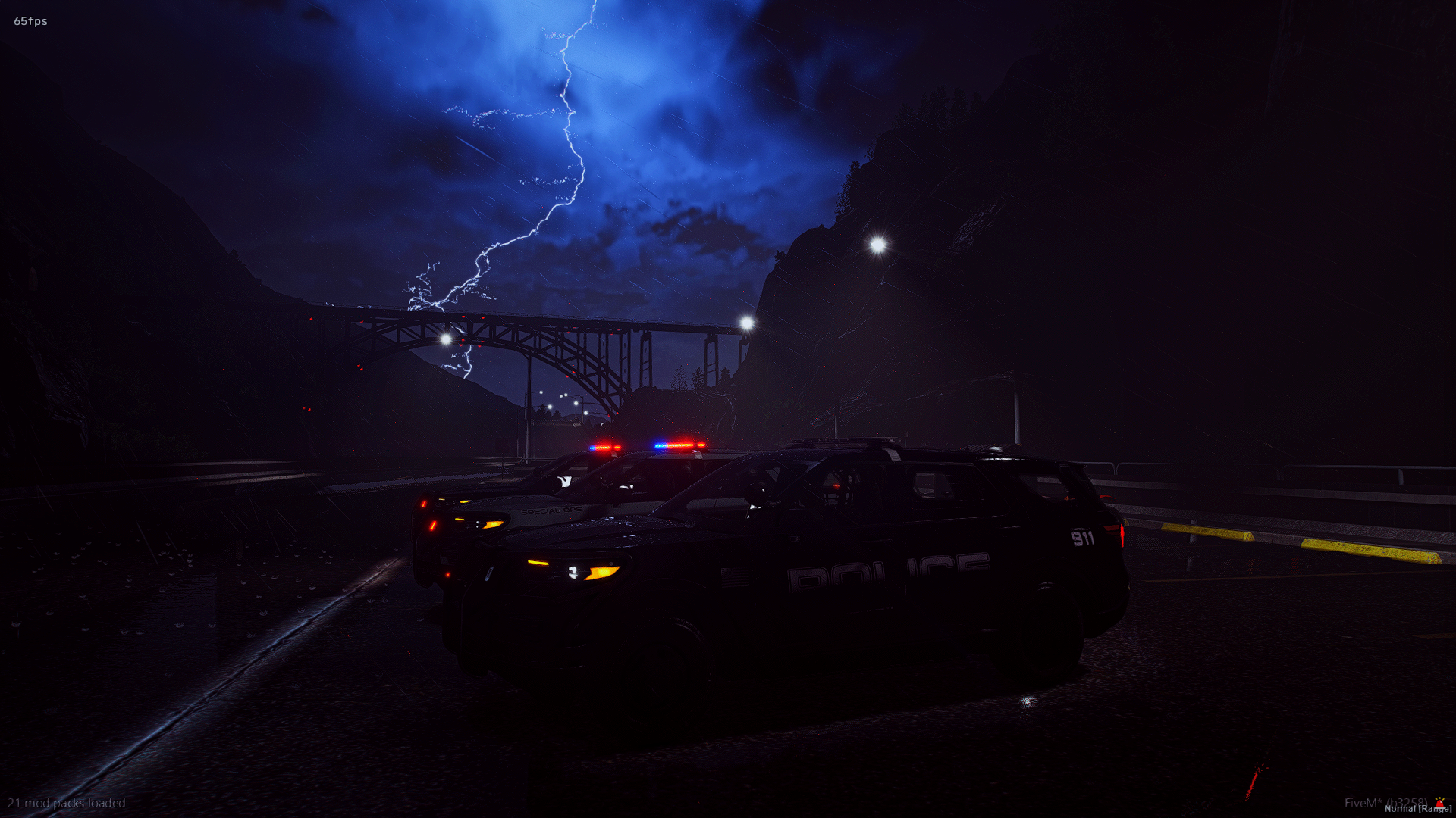 A dark scene at night showing police cars with flashing lights parked on a wet road as lightning strikes overhead in the cloudy sky, with a bridge in the background.