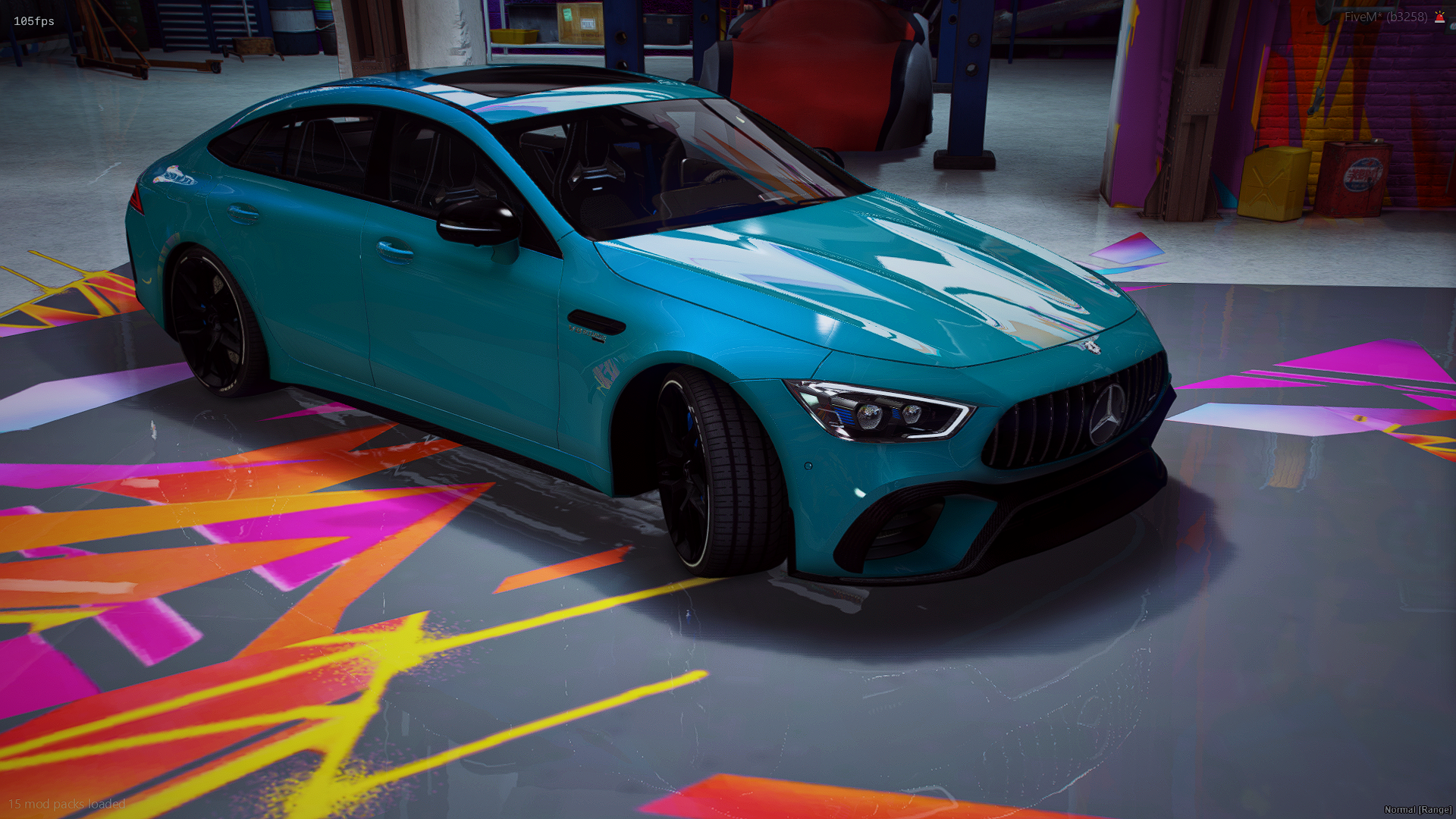 A blue Mercedes-Benz sports car inside a garage with graffiti-style colorful floor art and workshop tools and equipment in the background.