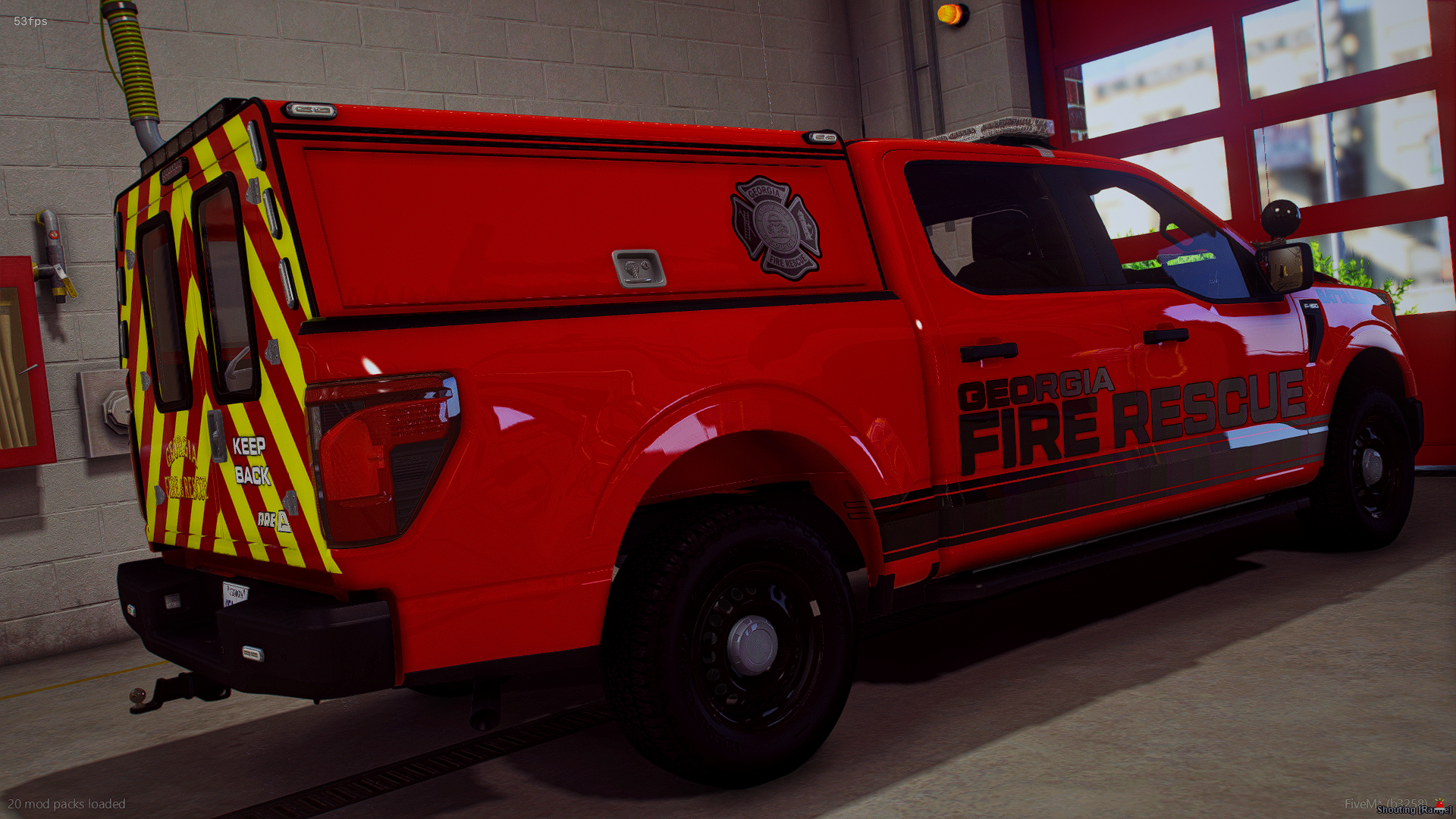 Red Georgia fire rescue utility truck parked indoors near a wall with warning labels and a window.