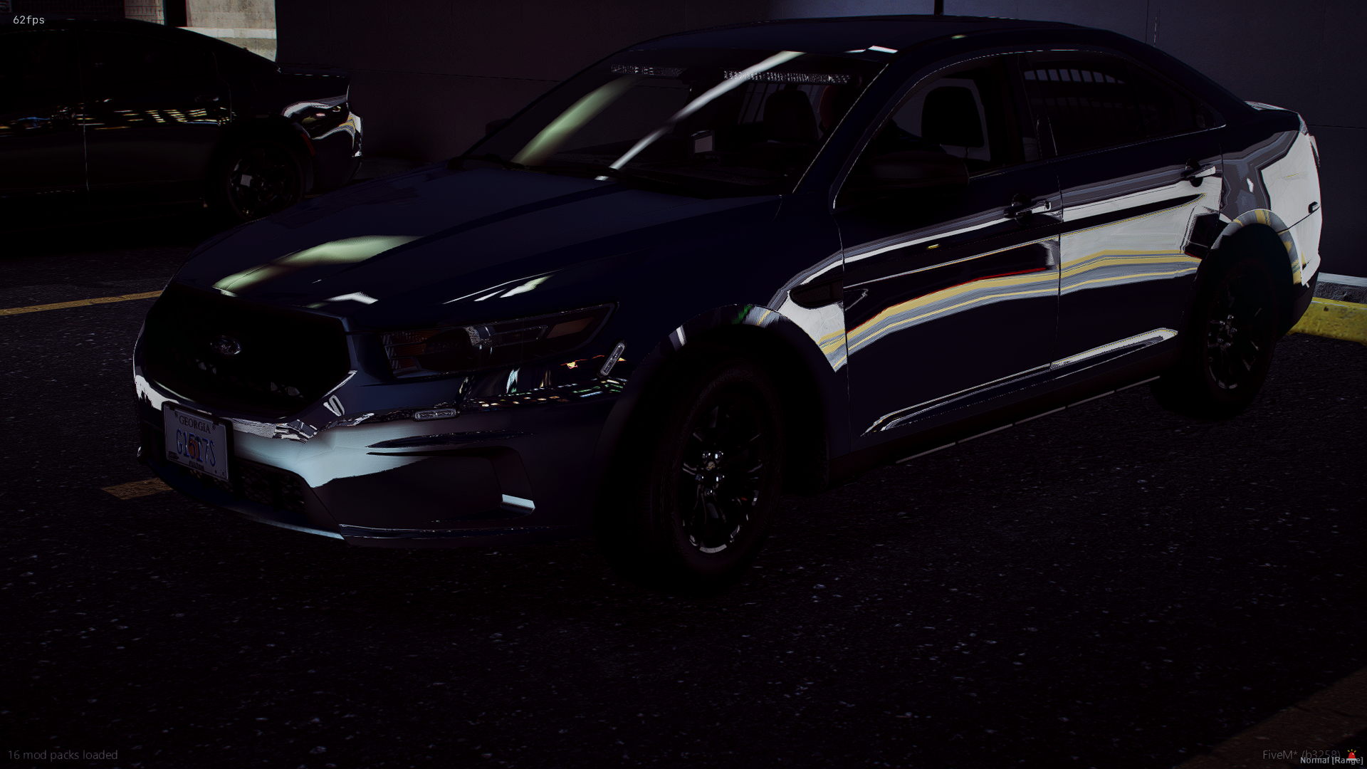 A black Ford Mustang parked in a dimly lit parking garage. Another vehicle, possibly a sedan, is partially visible beside it.