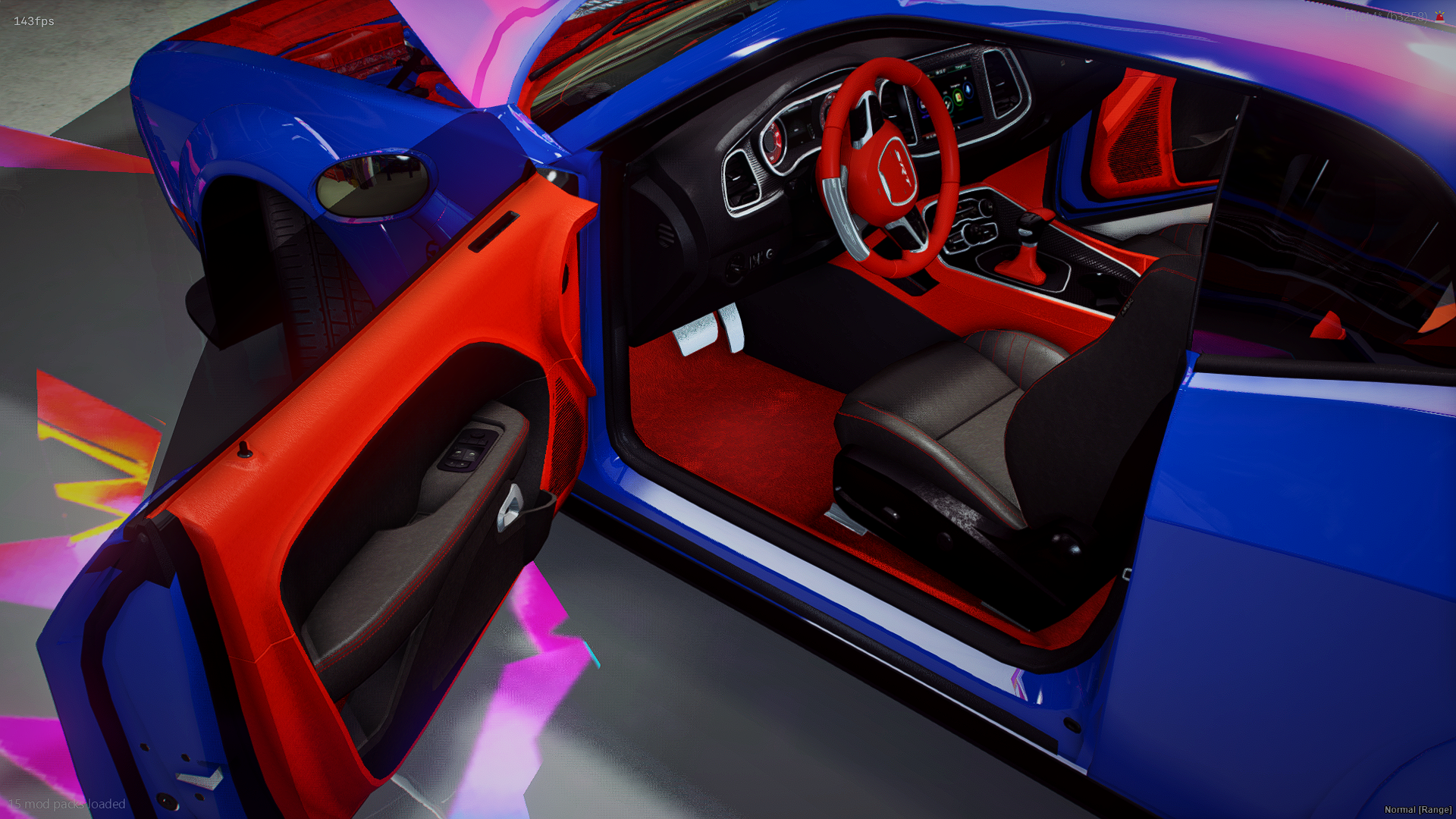Interior of a blue sports car with a red dashboard, red and black steering wheel, and black seats with red stitching.