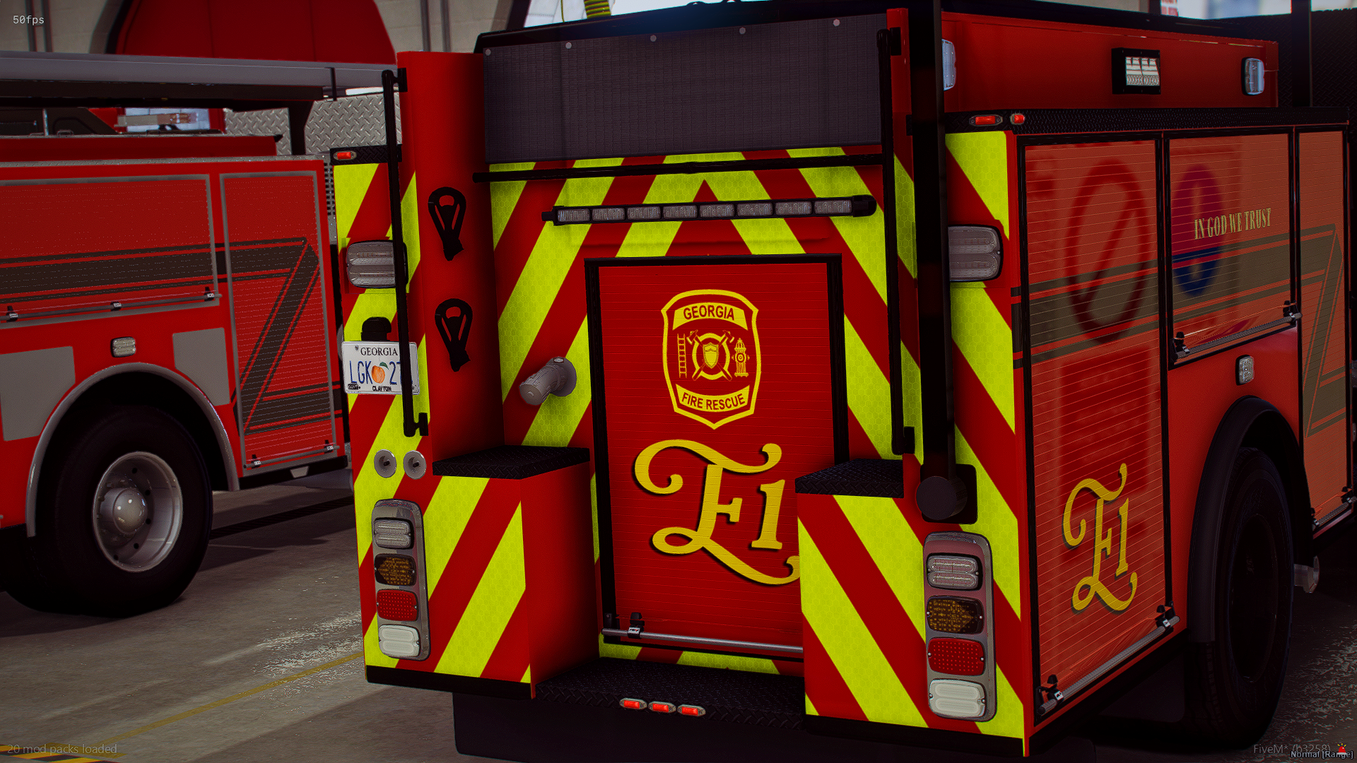 Rear view of a red fire rescue truck with yellow and red warning stripes, emergency lights, and equipment compartments.