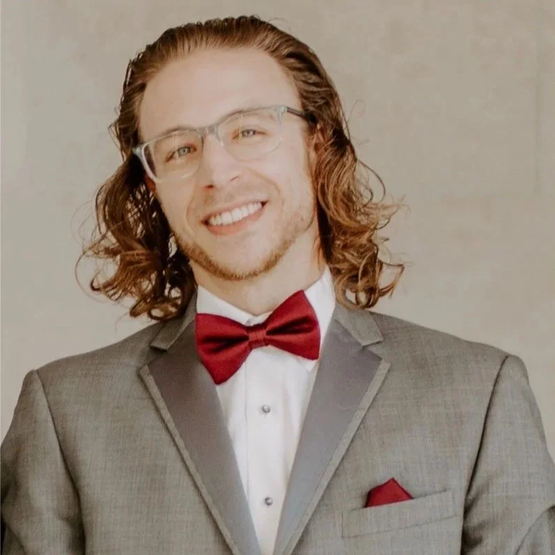 Flightbox CSO Shaun Walling in grey suit, white shirt, and red tie and pocket square.