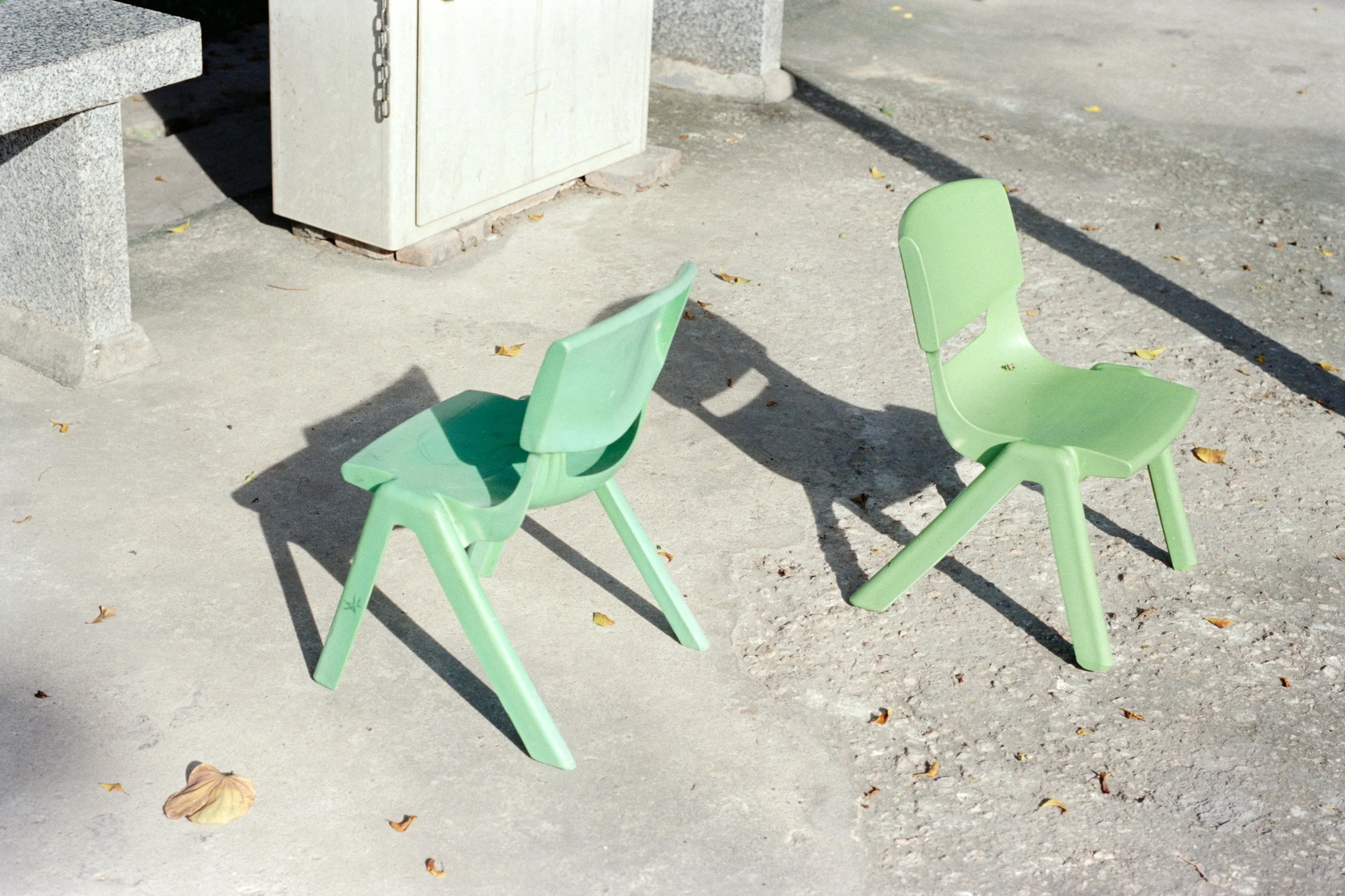 Couples therapy in San Diego. Two green plastic chairs facing opposite directions.