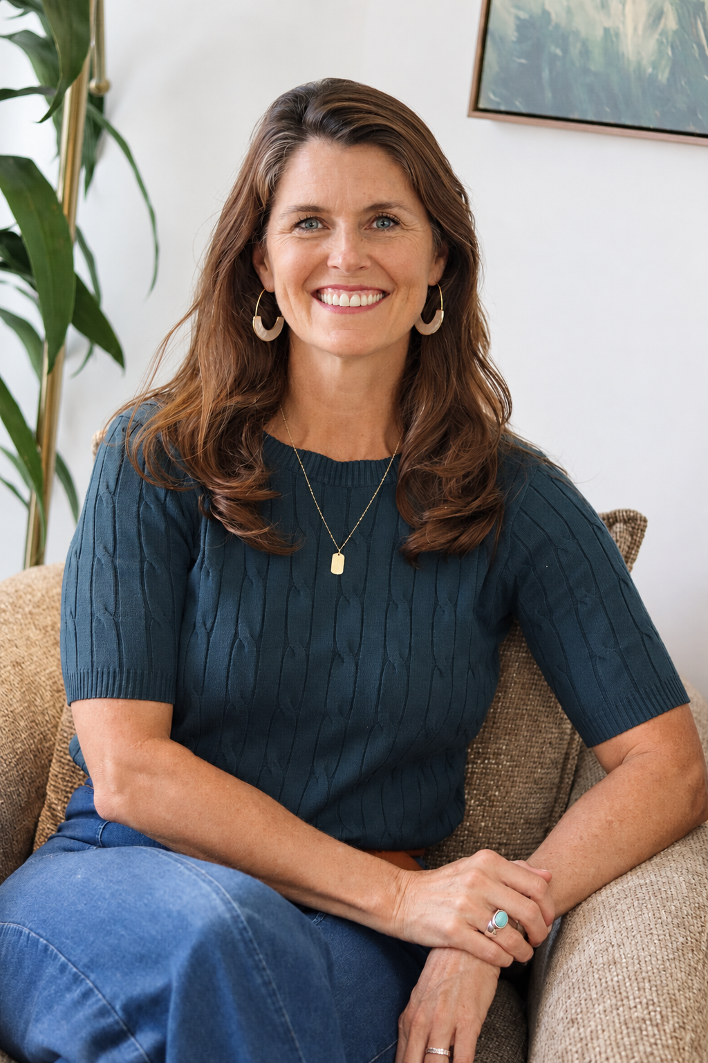 Woman with light brown hair wearing turquoise ring smiling