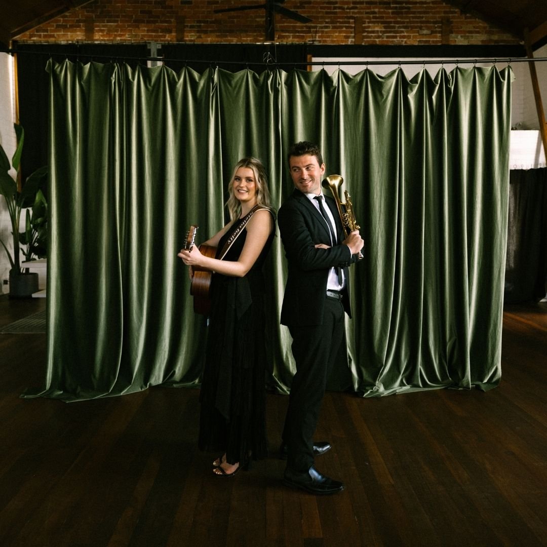 Stella Kelly singing and playing guitar with Sam T on trumpet