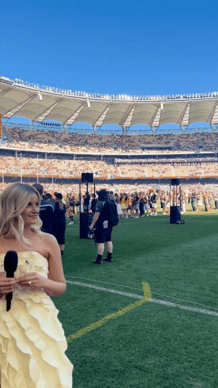 Stella Kelly singing at AFL Origin at Optus Stadium in Perth, Western Australia