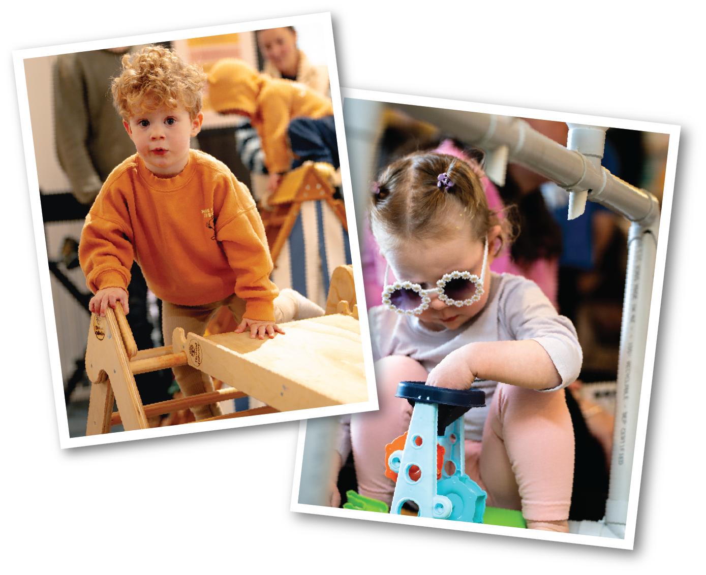 Two children playing at an indoor playground: a young boy with curly hair in an orange sweater, and a girl with braided hair and sunglasses, playing with a toy.
