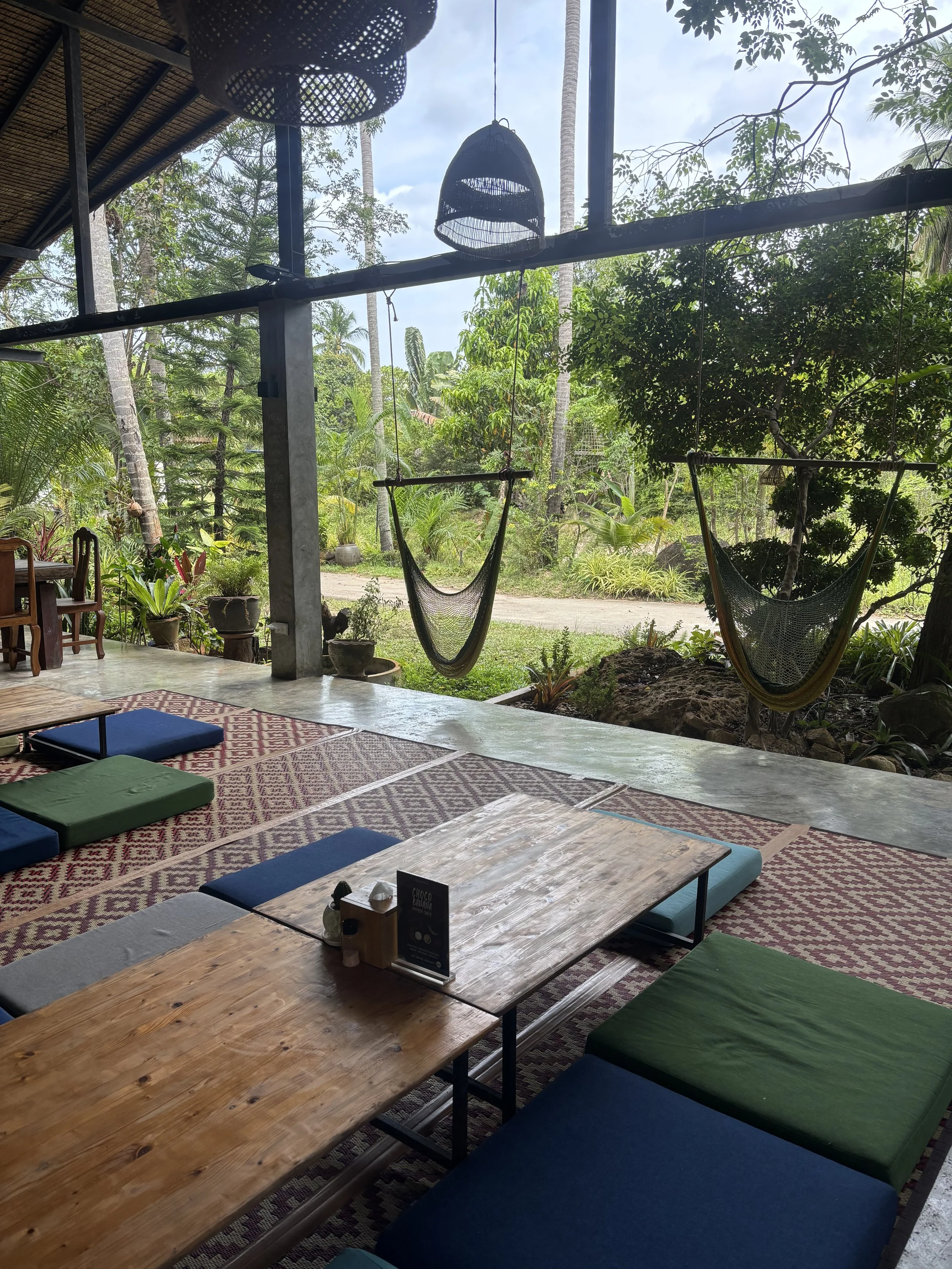 Dining area at the retreat venue, surrounded by lush tropical nature in Koh Phangan, Thailand