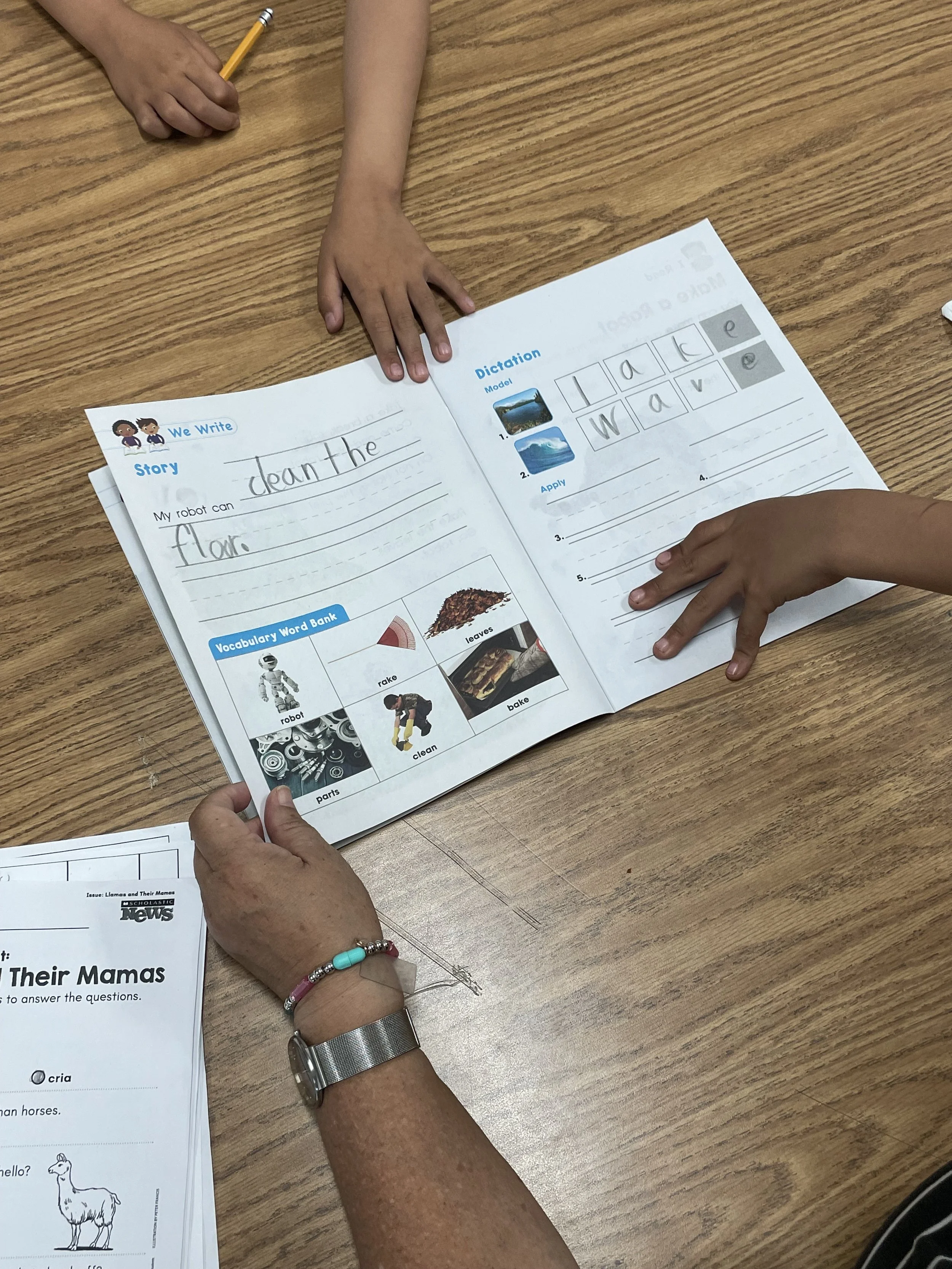 PT student workbook w kids and teacher hands on it.jpeg