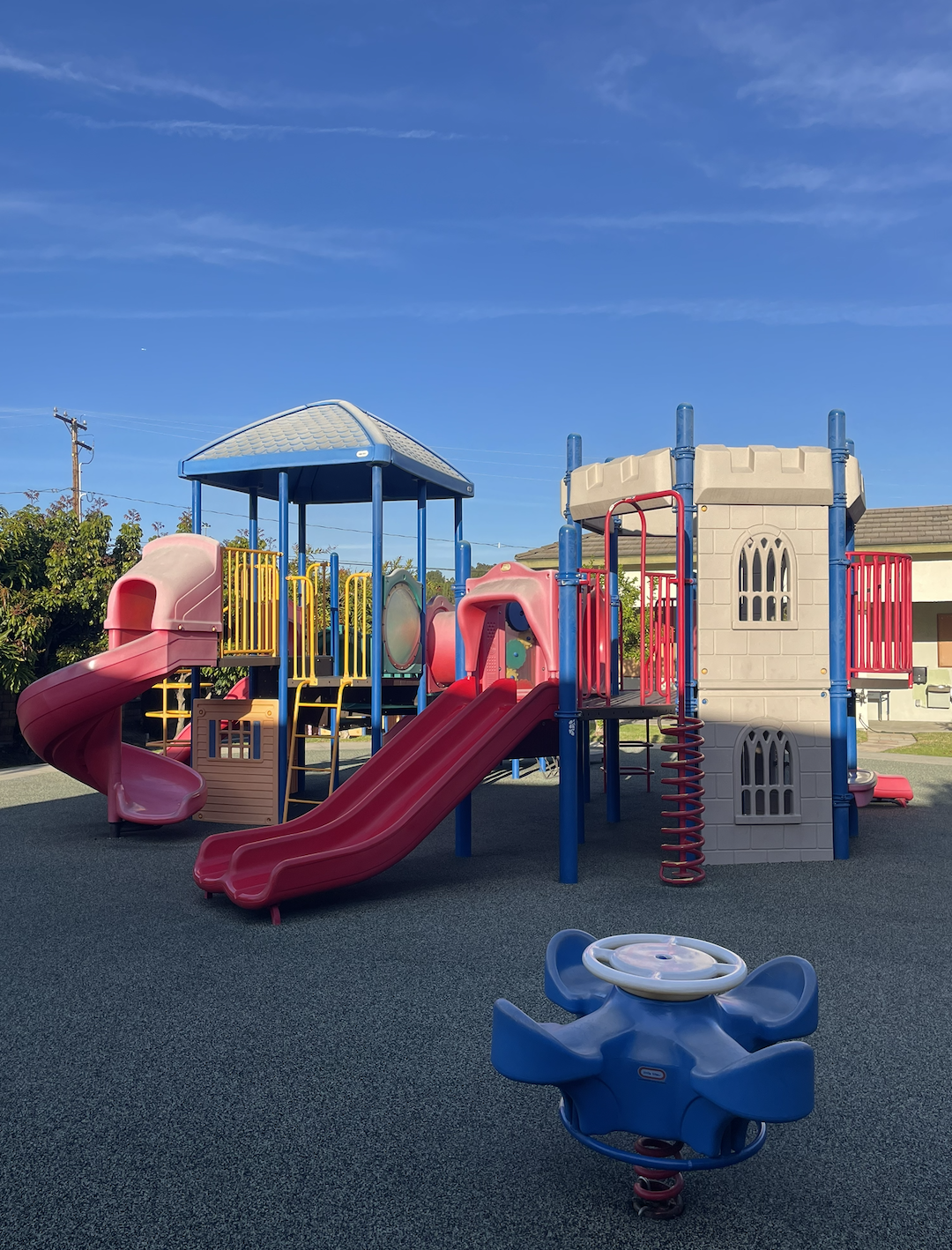 Private preschool/kindergarten playground area with multiple slides and attractions in Walnut, CA
