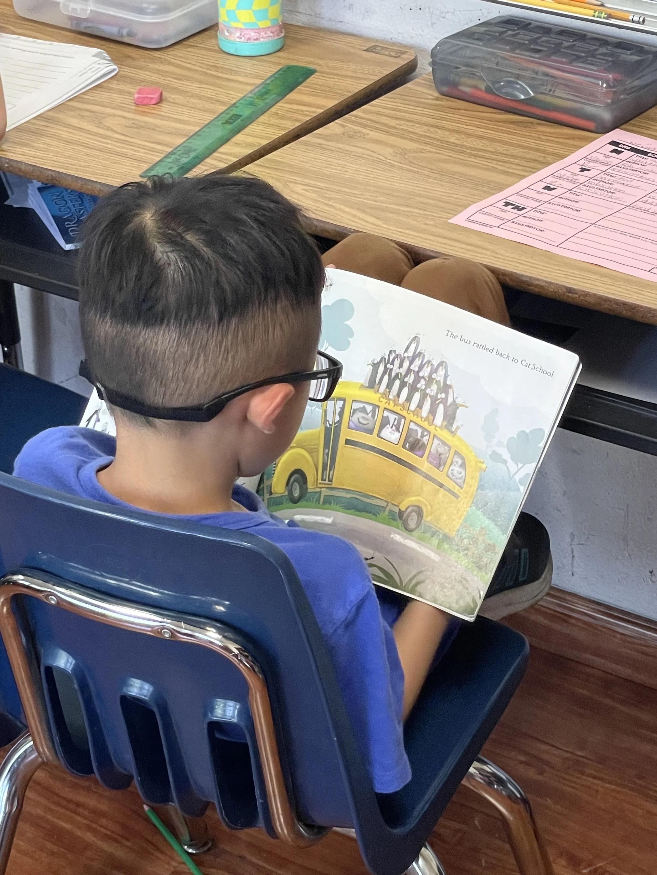 PT boy with glasses reading.jpeg